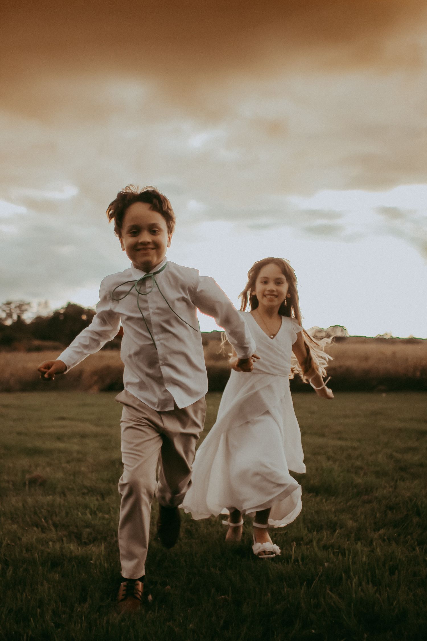 Children running through field at wedding, warm nostalgic moody light wedding in Milaca, Minnesota  Elk River, MN Photographer Photography
