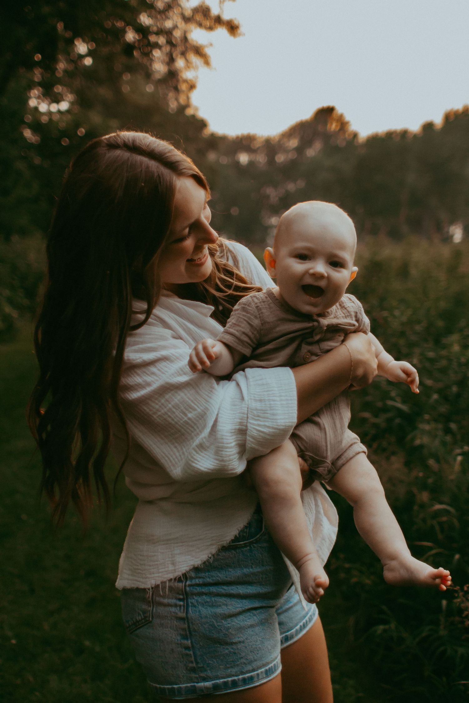 A mother and baby during golden hour in Elk River, Minnesota Photographer Photography Wedding Couples Engagement Session Senior Unique