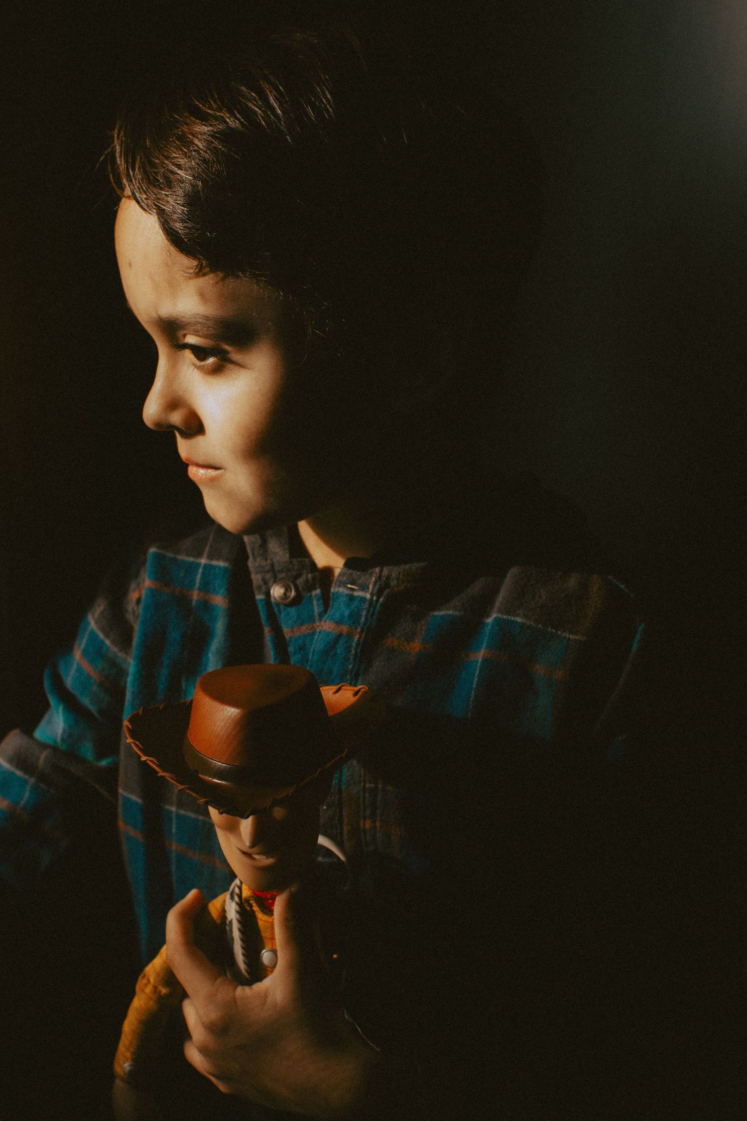 A young boy with Woody toy, Minnesota lifestyle indoor session with toys, Elk River, Minnesota Photographer Photography Wedding Couples