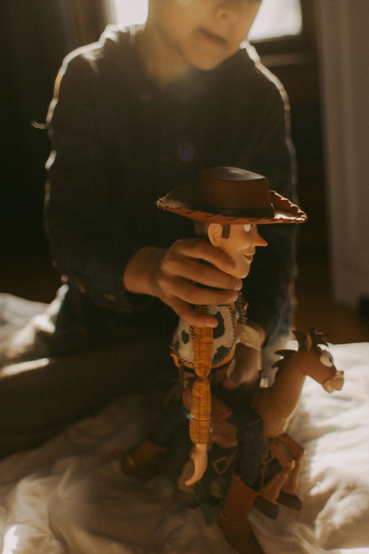 A young boy with Woody toy, Minnesota lifestyle indoor session with toys. Elk River, Minnesota MN Photographer Photography Wedding Couples