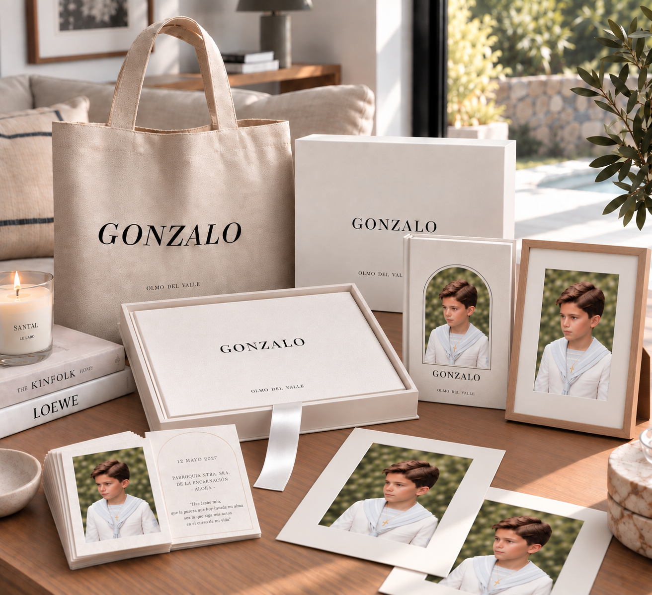 Personalized Gonzalo communion keepsake set with tote bag, gift boxes, framed photos, prints and invitation cards on a wooden table.