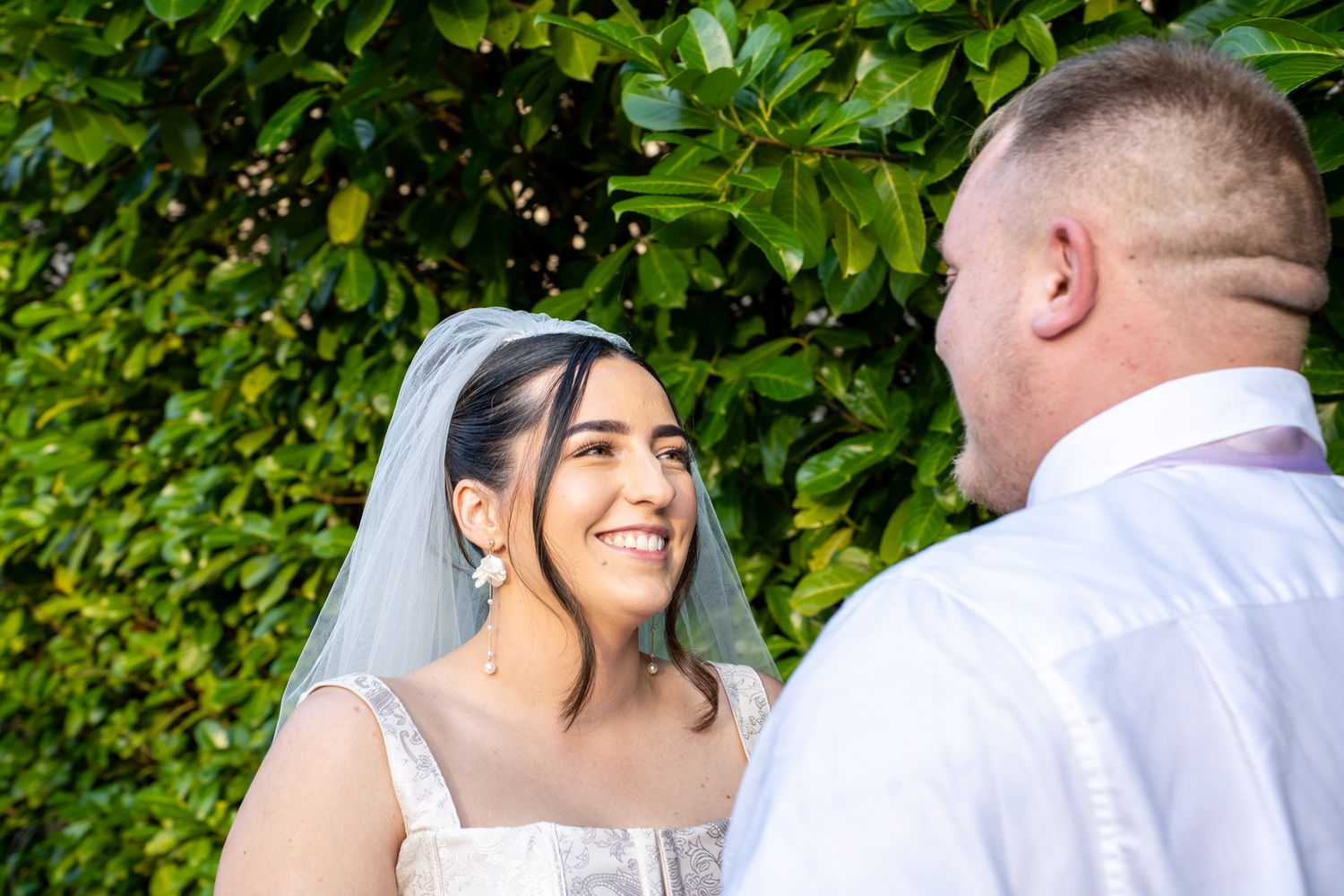 Outdoor photo of bride and groom at Airdrie registry office, natural and candid wedding photography capturing authentic love