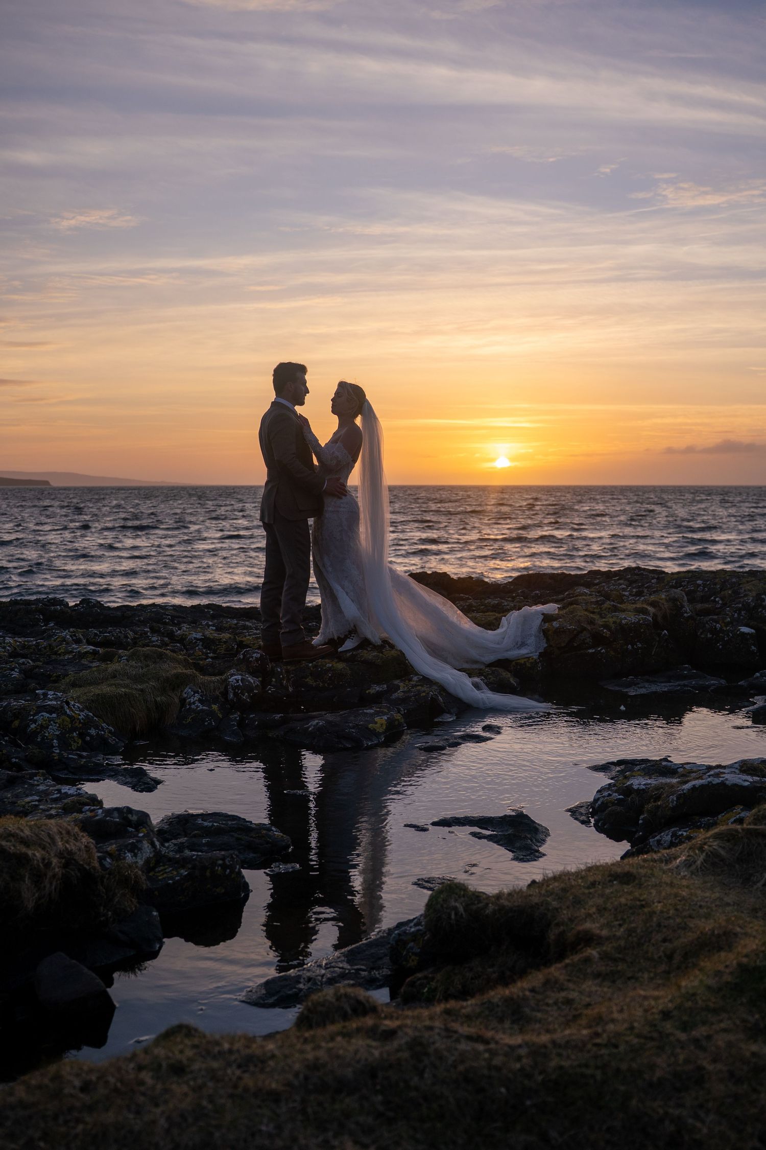 Bride and groom at sunset on Isle of Skye, Scotland, romantic and natural wedding photography capturing authentic love and emotional moments