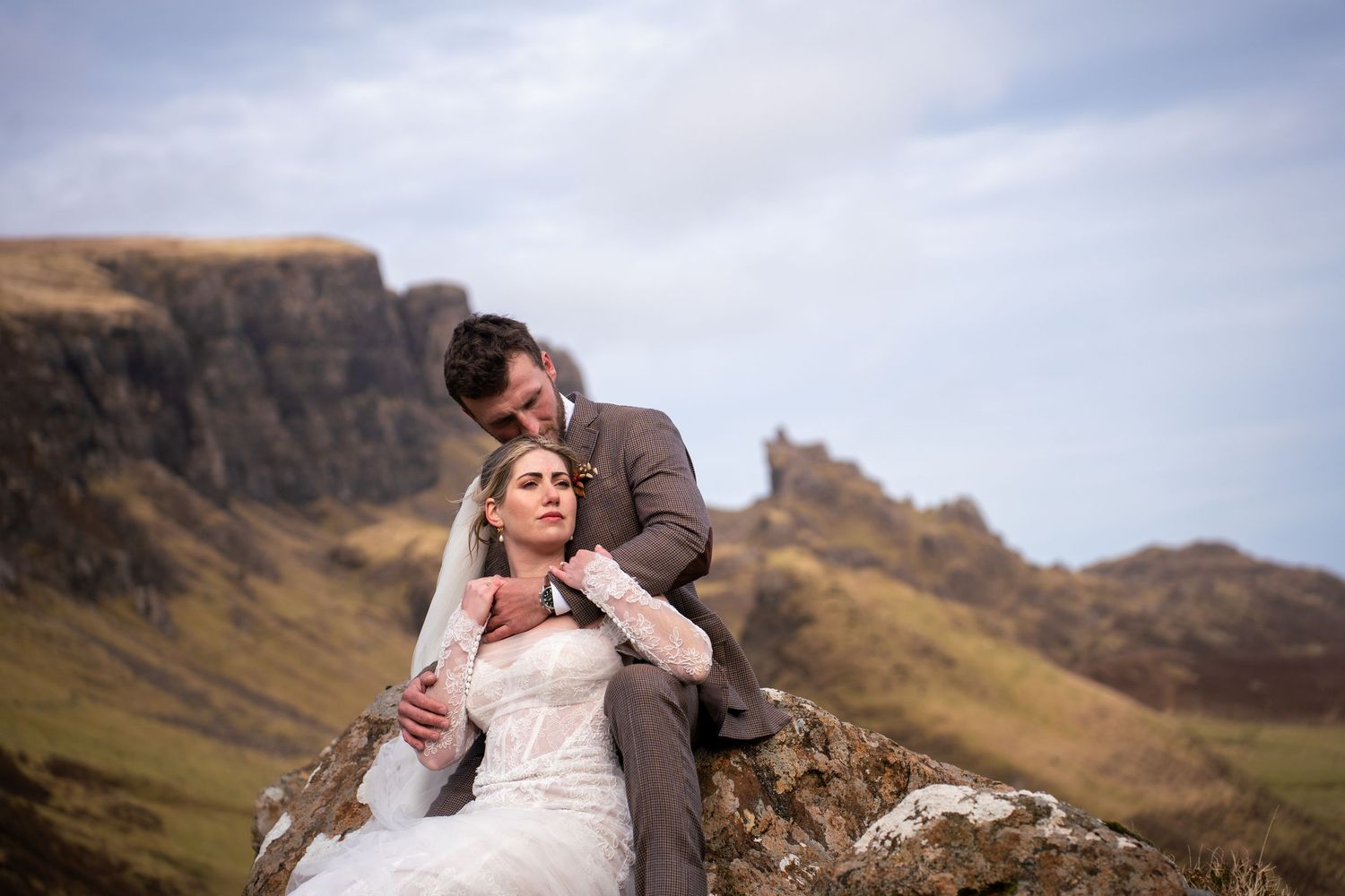 Couple embracing at The Quiraing, Isle of Skye, romantic and natural wedding photography capturing authentic love and emotional moments