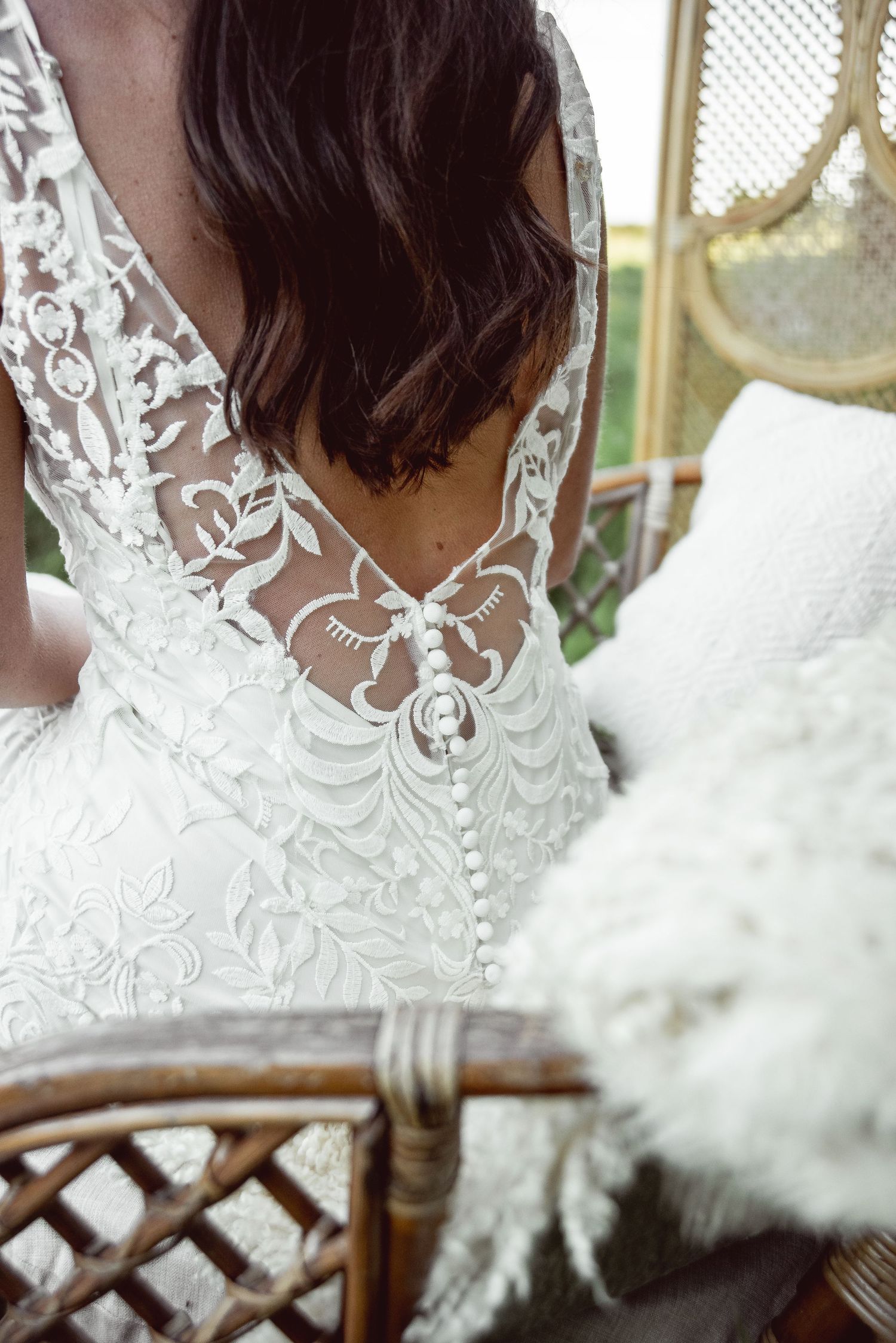 Detailed view of intricate white lace pattern on wedding dress bodice.