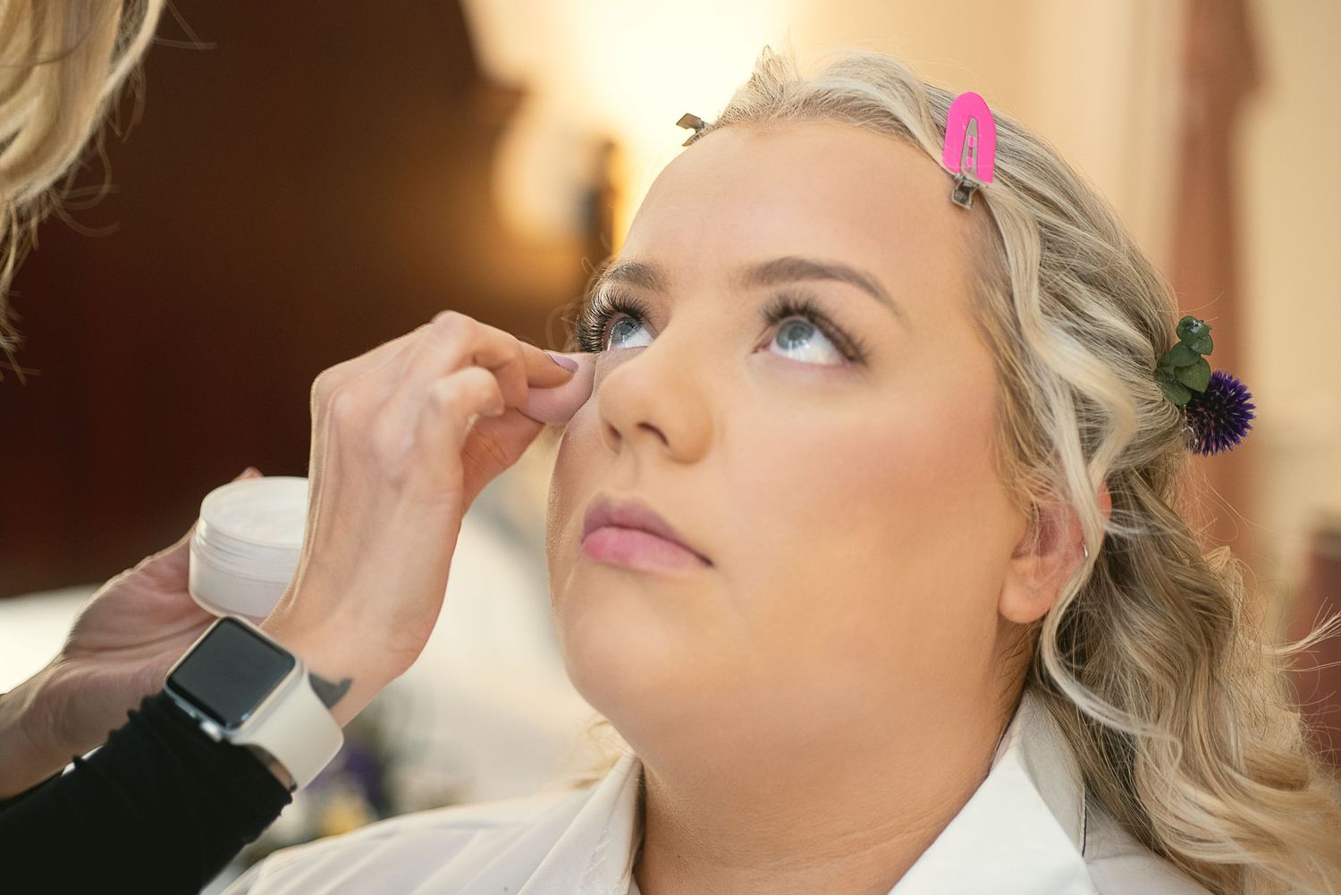 Wedding day makeup preparation with professional brushes and beauty products.
