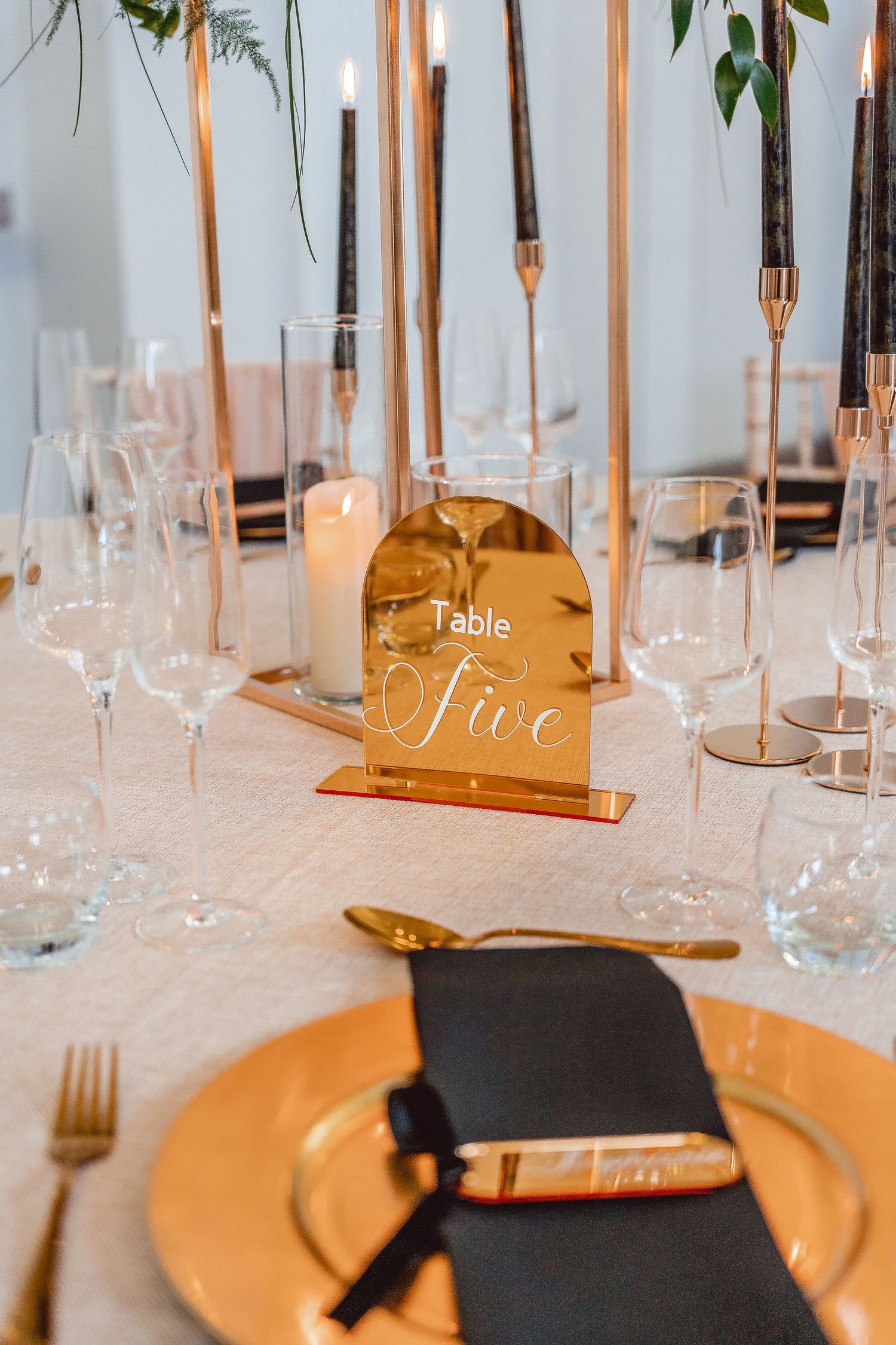 Detail shot of Gold table number and other gold and black table decor