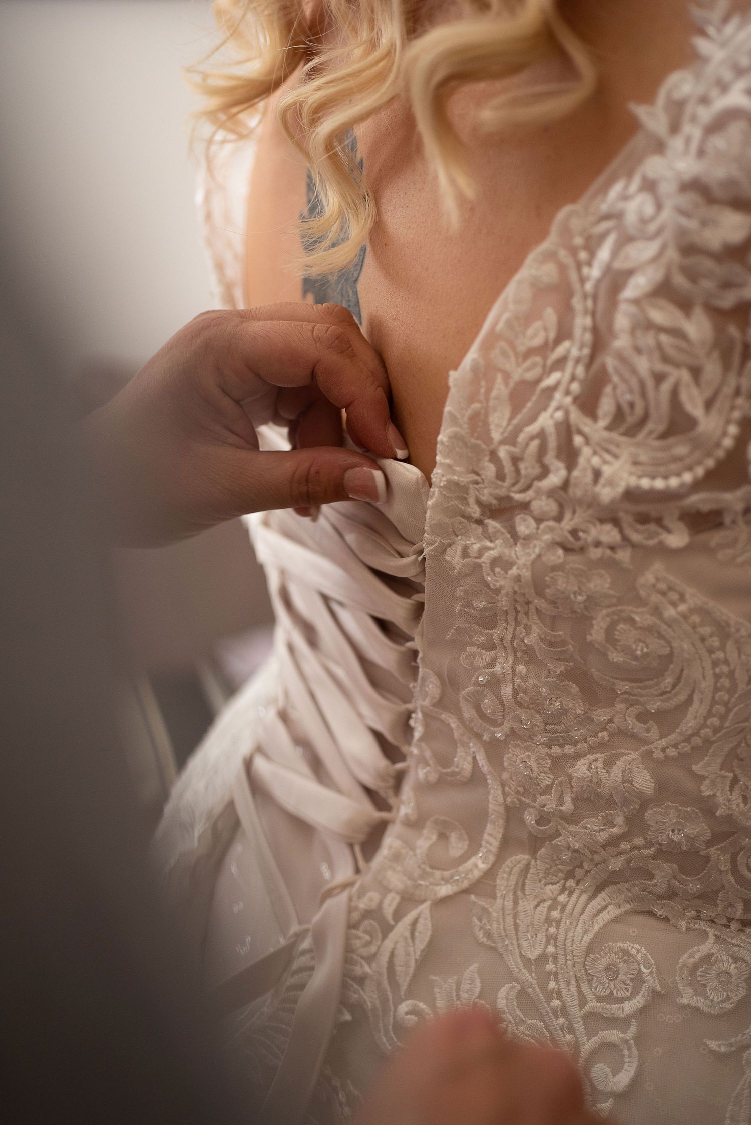 Close-up details of intricate lace patterns on a wedding dress bodice.