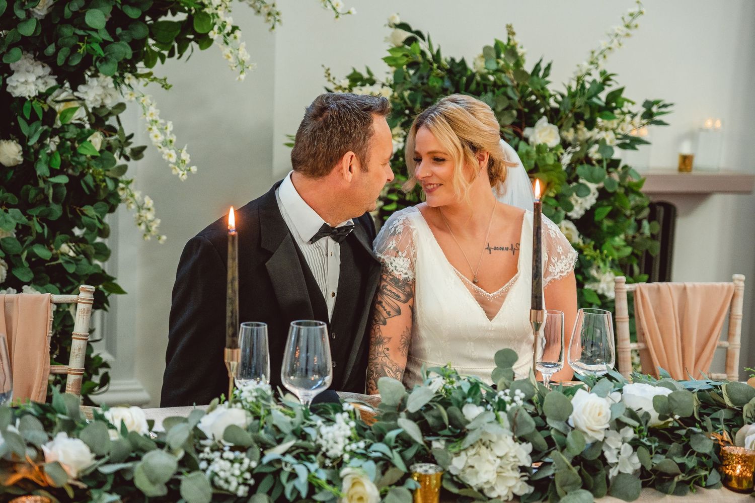 Bride and Groom sat at the top table looking at each other