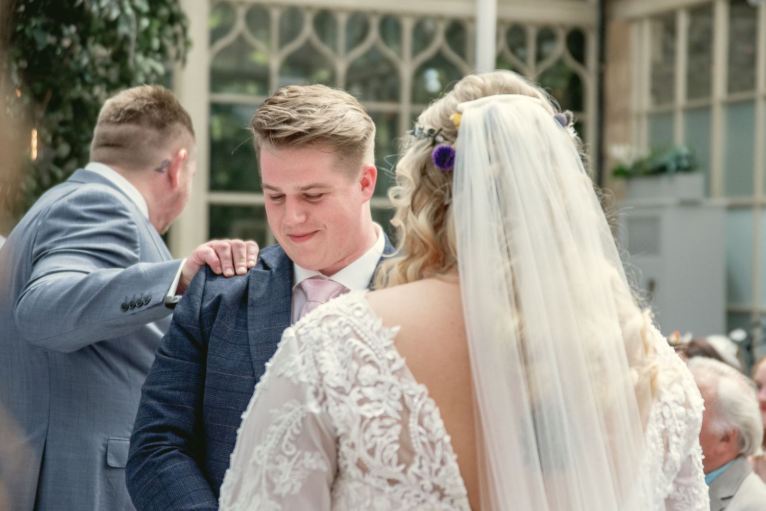 Emotional moment during wedding ceremony as couple exchanges rings.