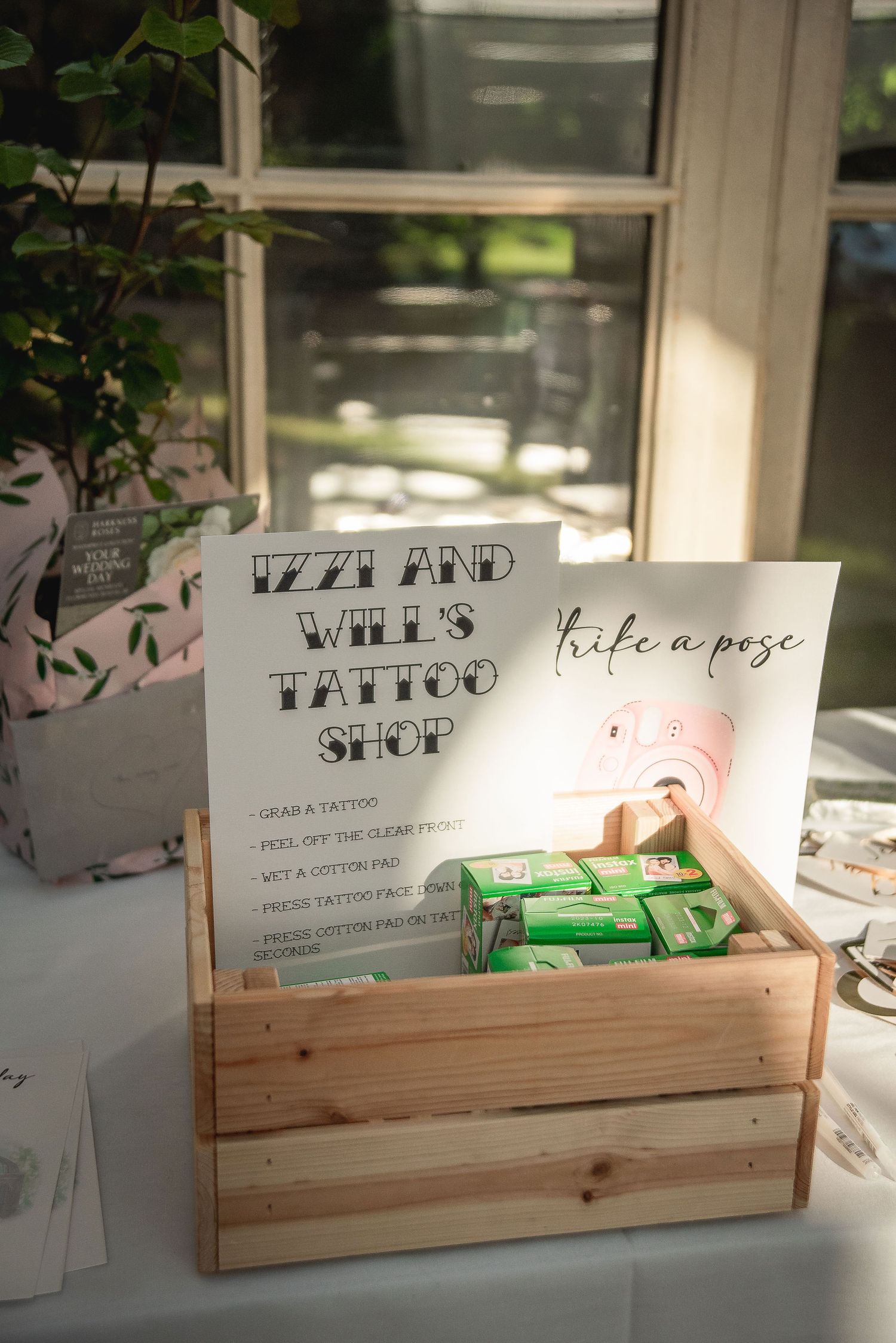 Wooden display box with vintage-style wedding signage and decorative elements.