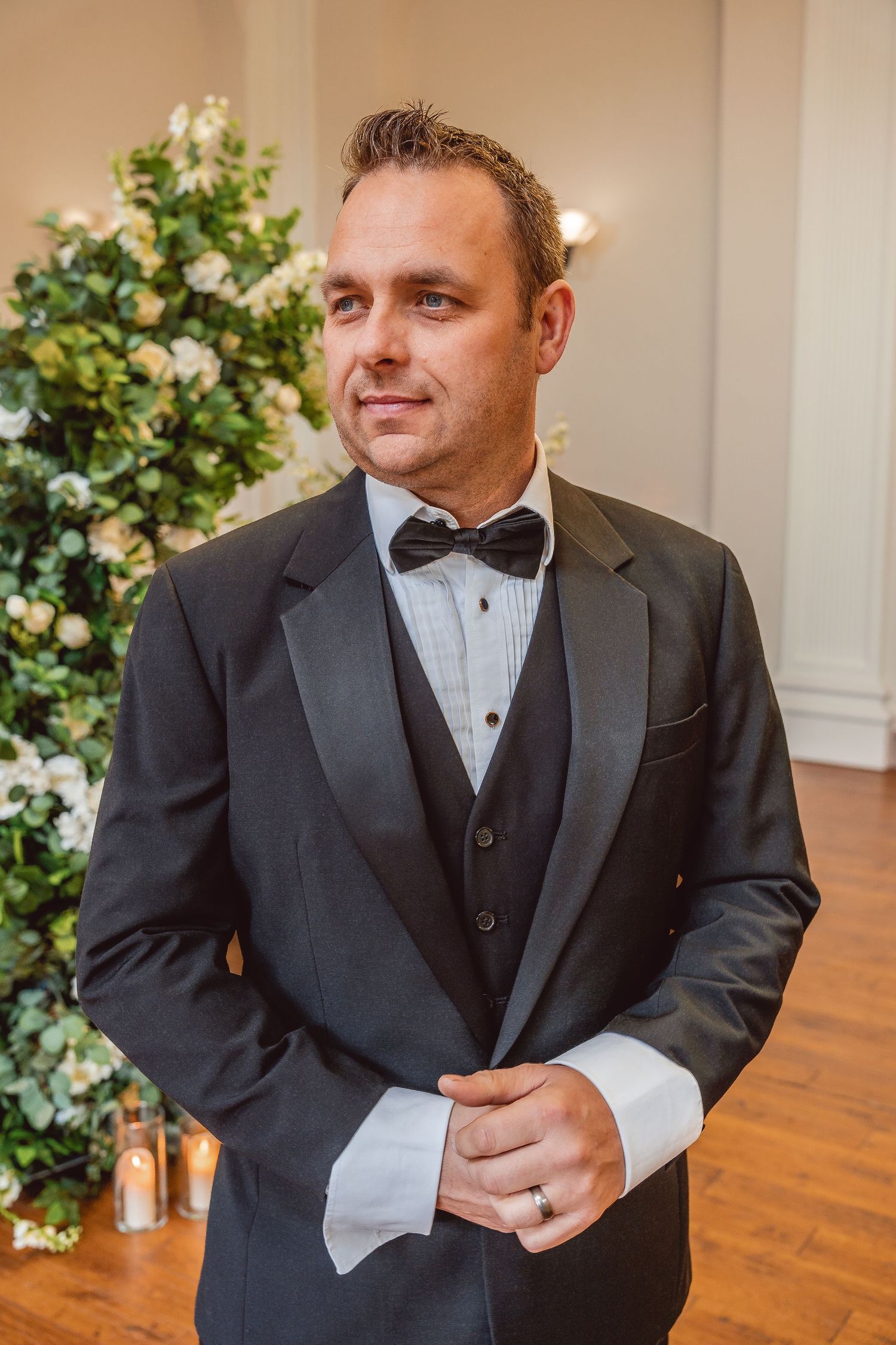 portrait of groom wearing a black tuxedo