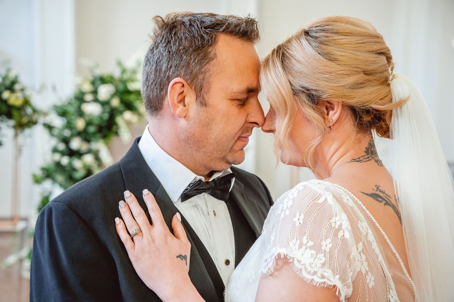 Close up portrait of Bride and Groom, foreheads touching