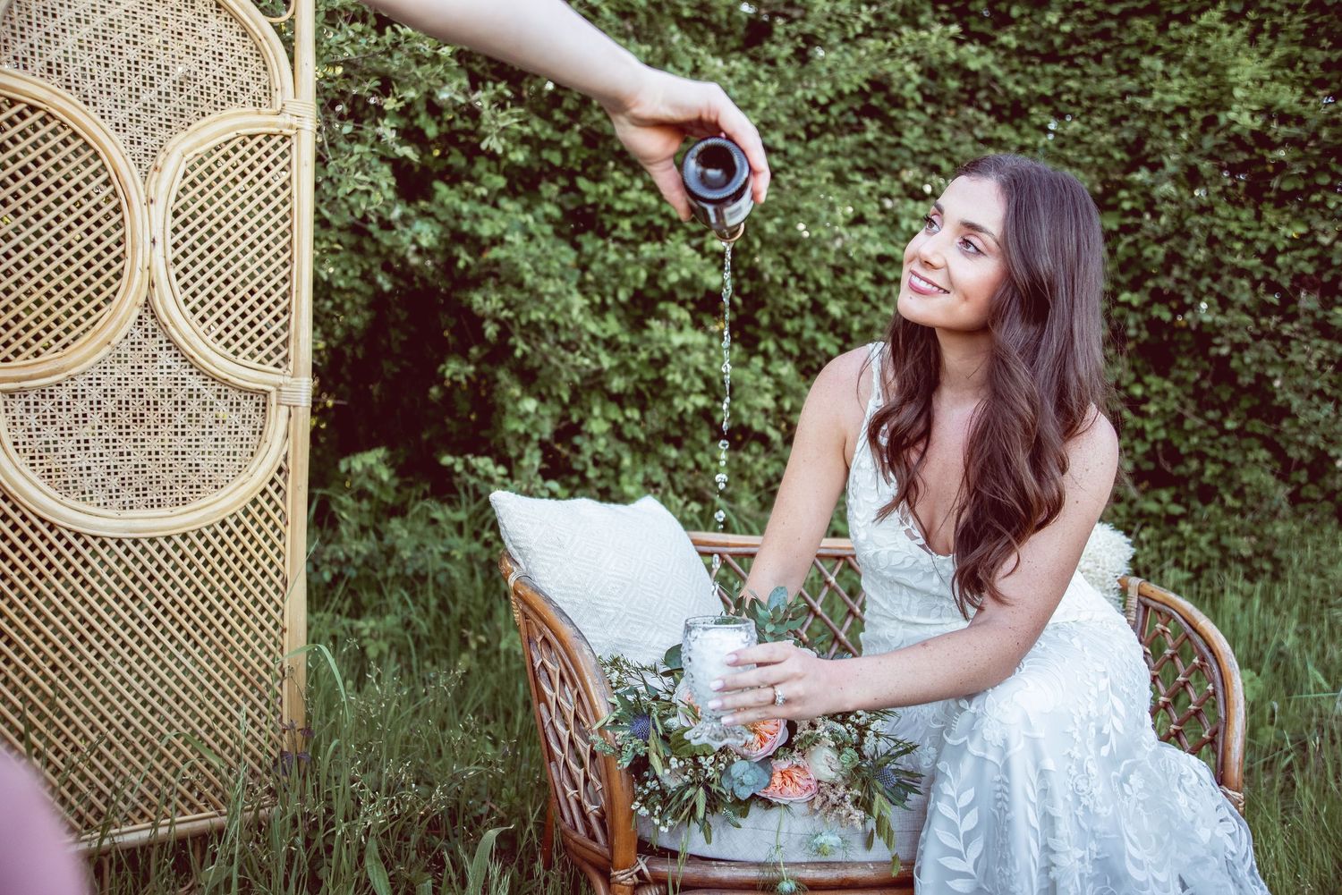 Vintage-inspired garden tea party setup with wicker furniture and bridal details.
