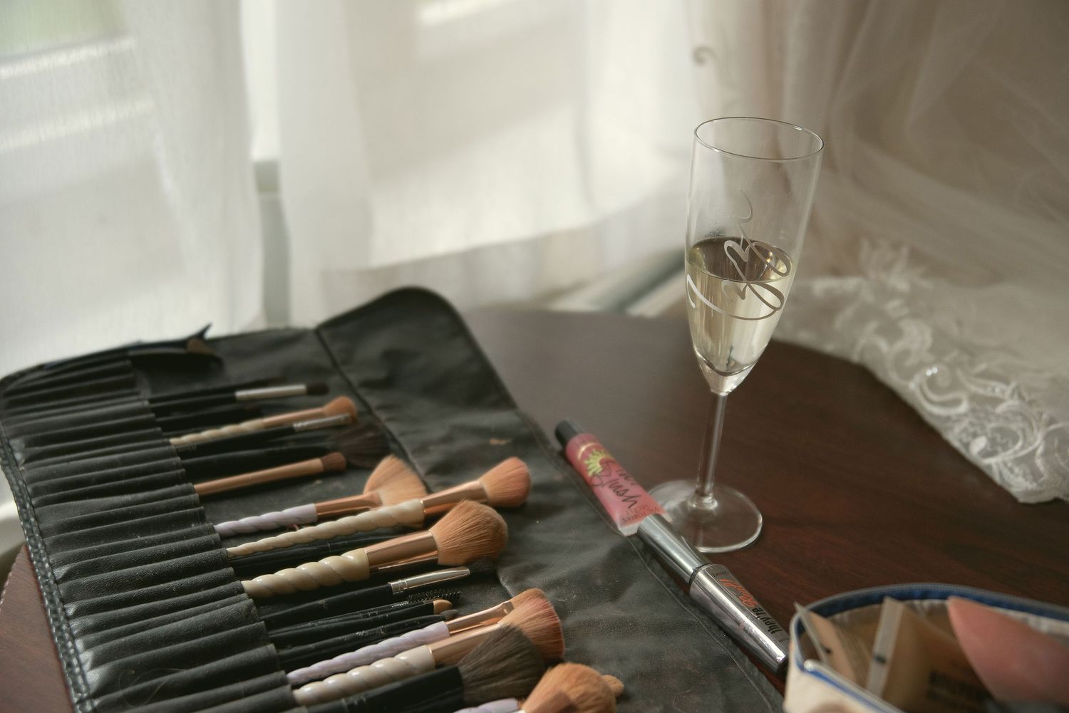 Professional makeup brushes arranged neatly in a black case on a white surface.