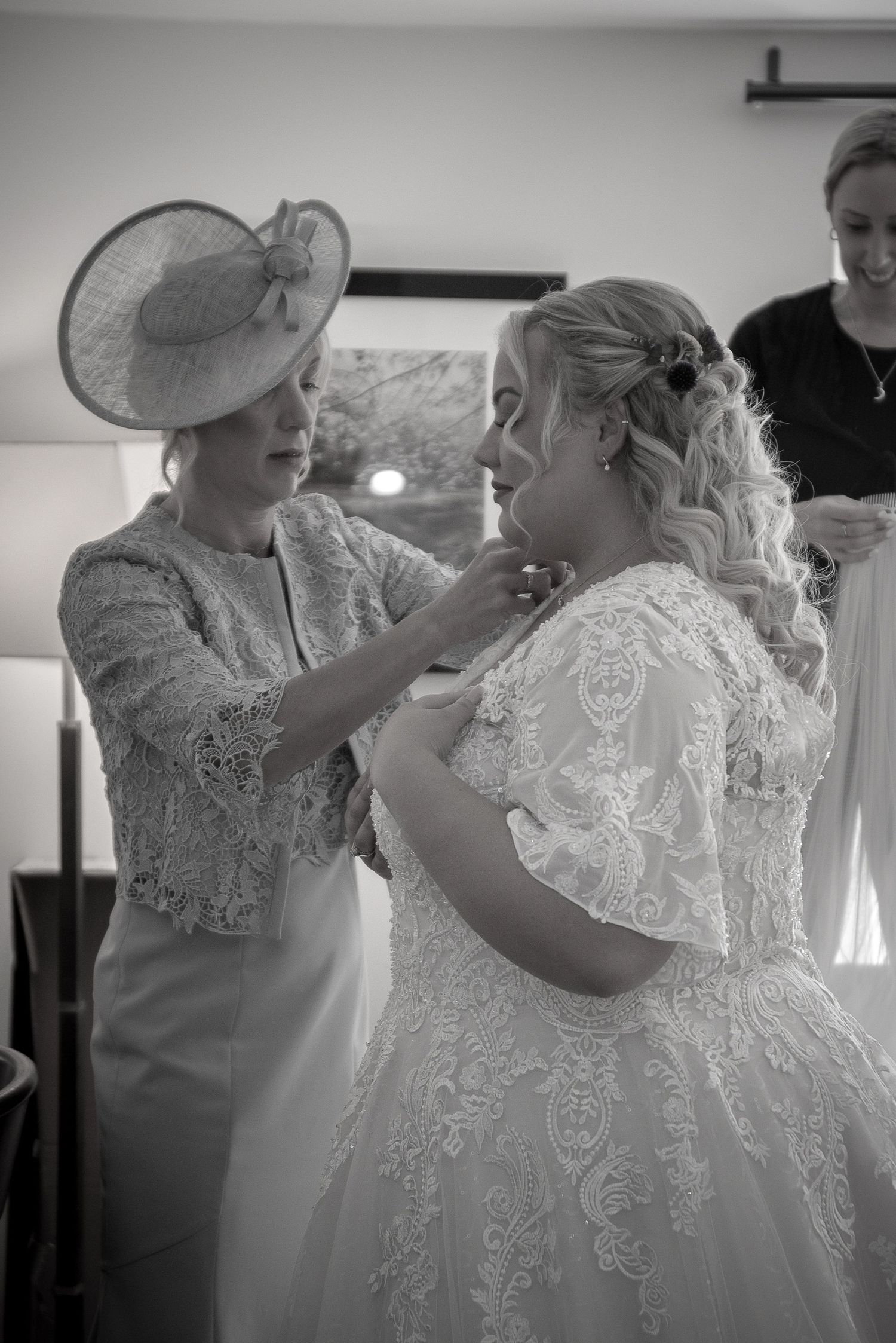 Wedding preparation moments showing final touches on bridal attire.