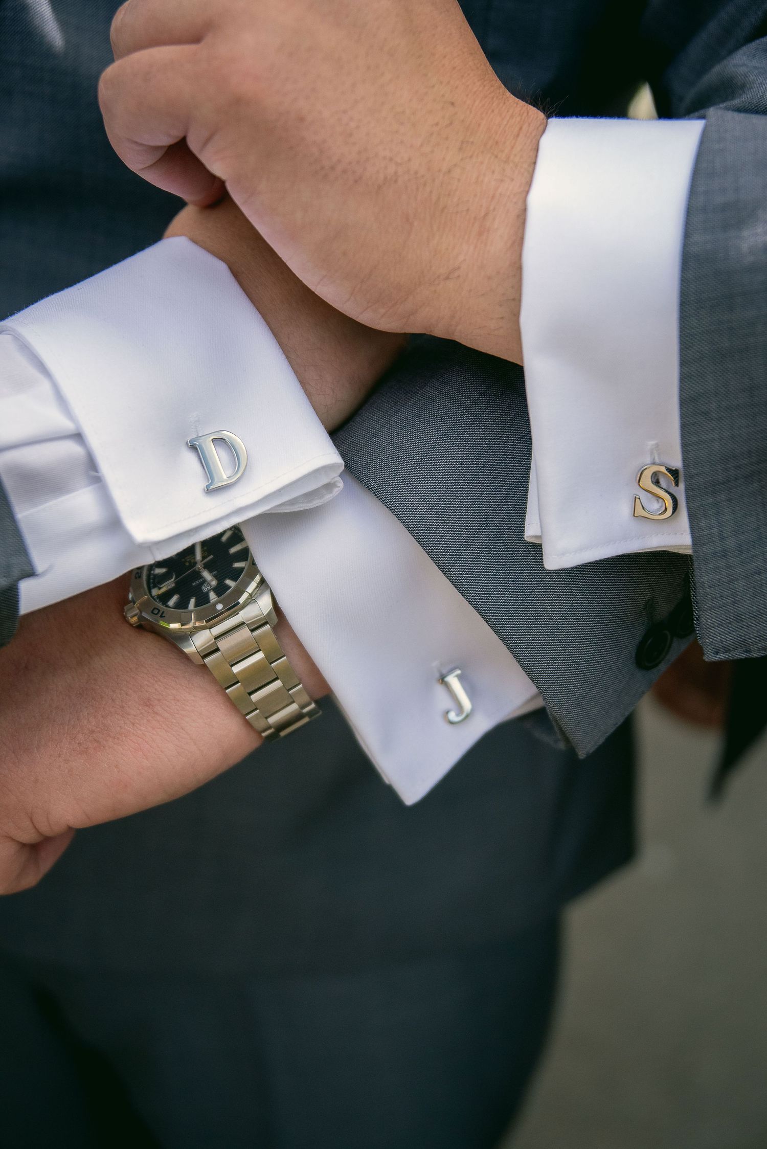 Detailed shots of formal white shirt cuffs and cufflinks with a watch.