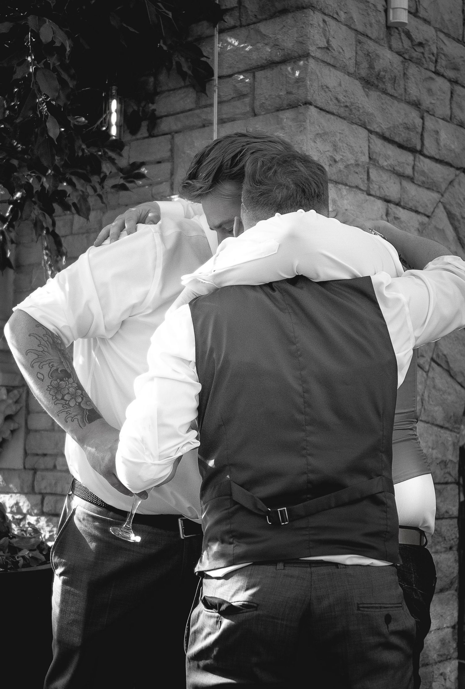 Black and white photo showing formal attire details at wedding reception.