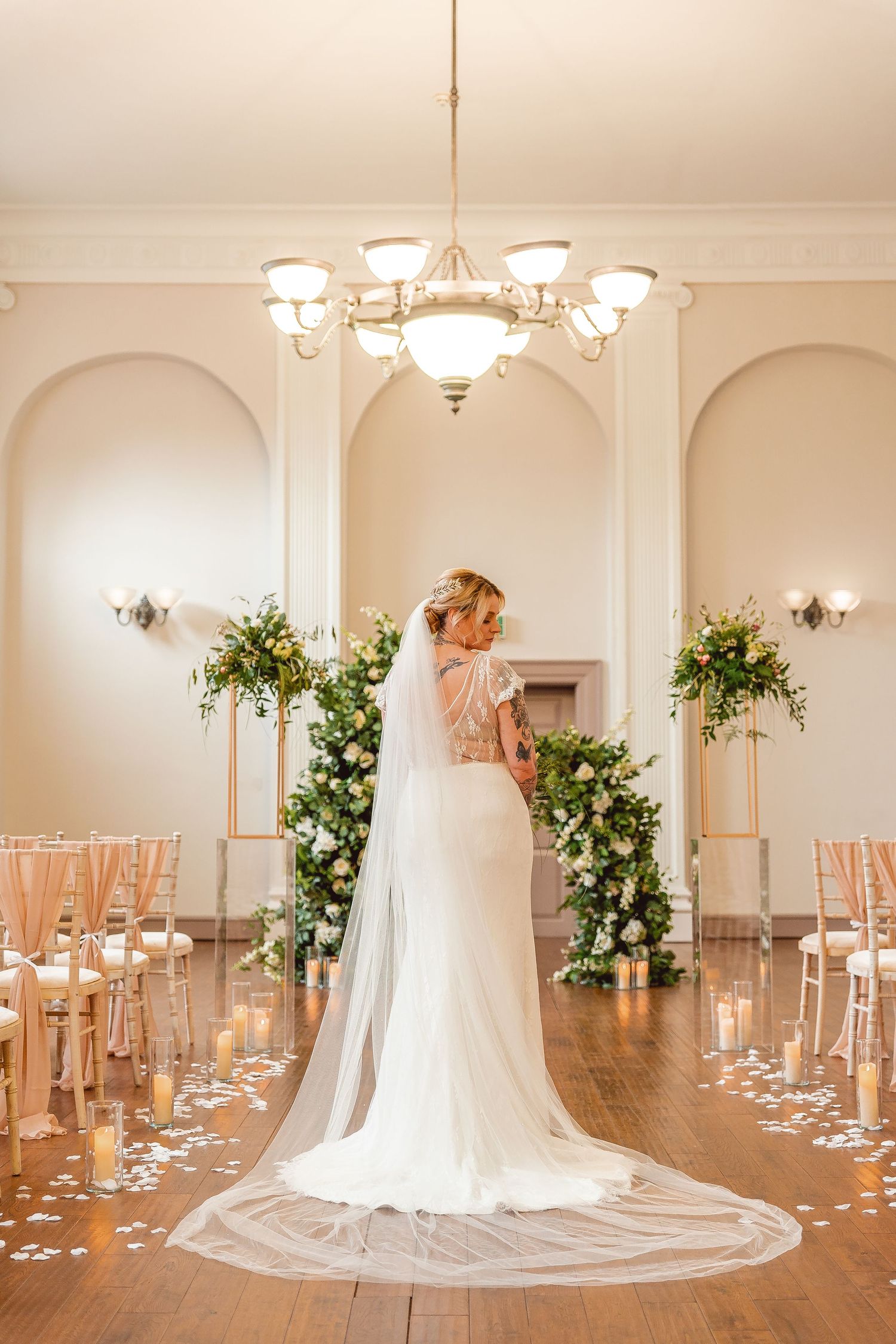 Full length view of the Brides' back standing in the aisle