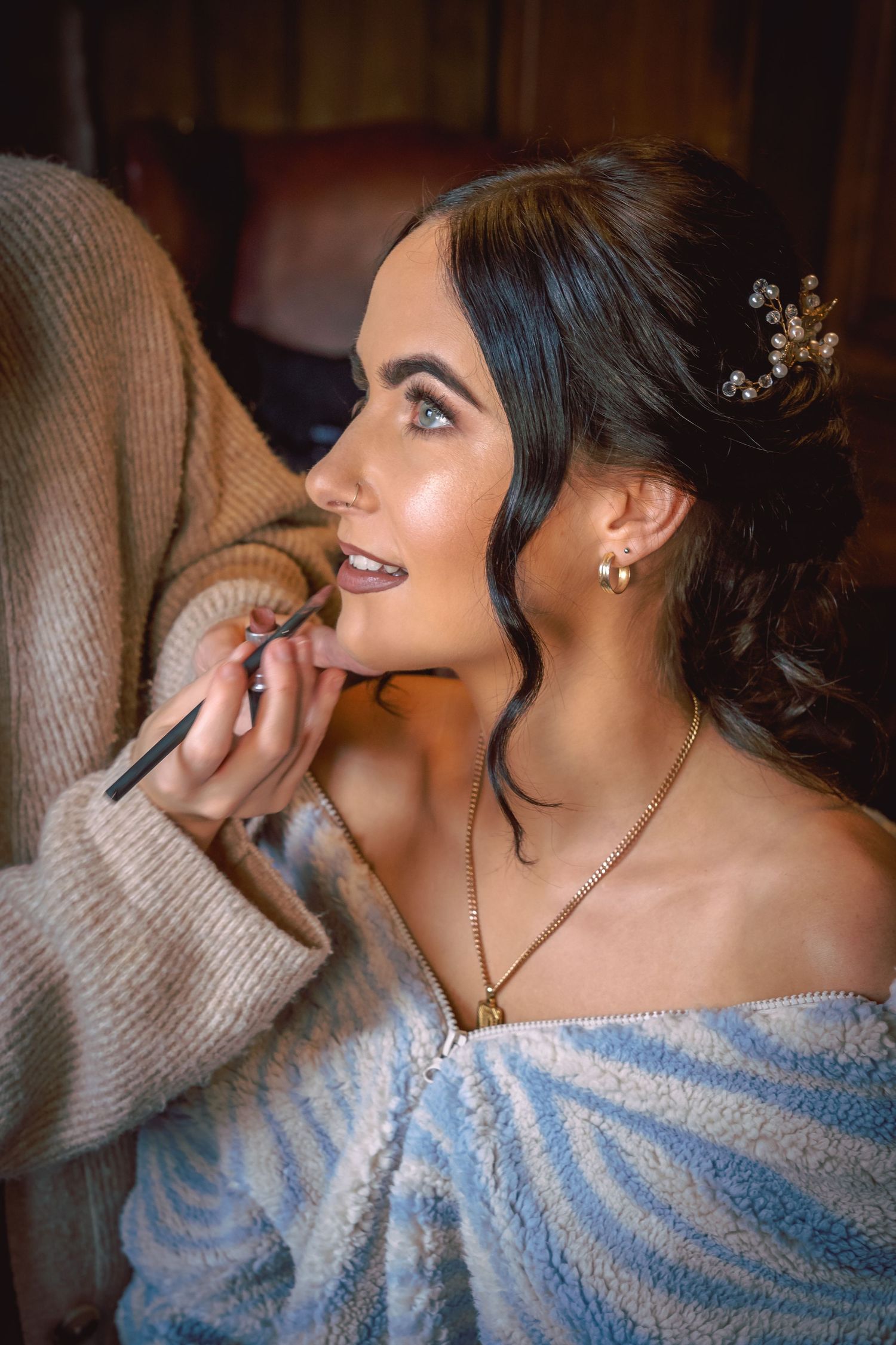 Close up of bride having lipstick put on