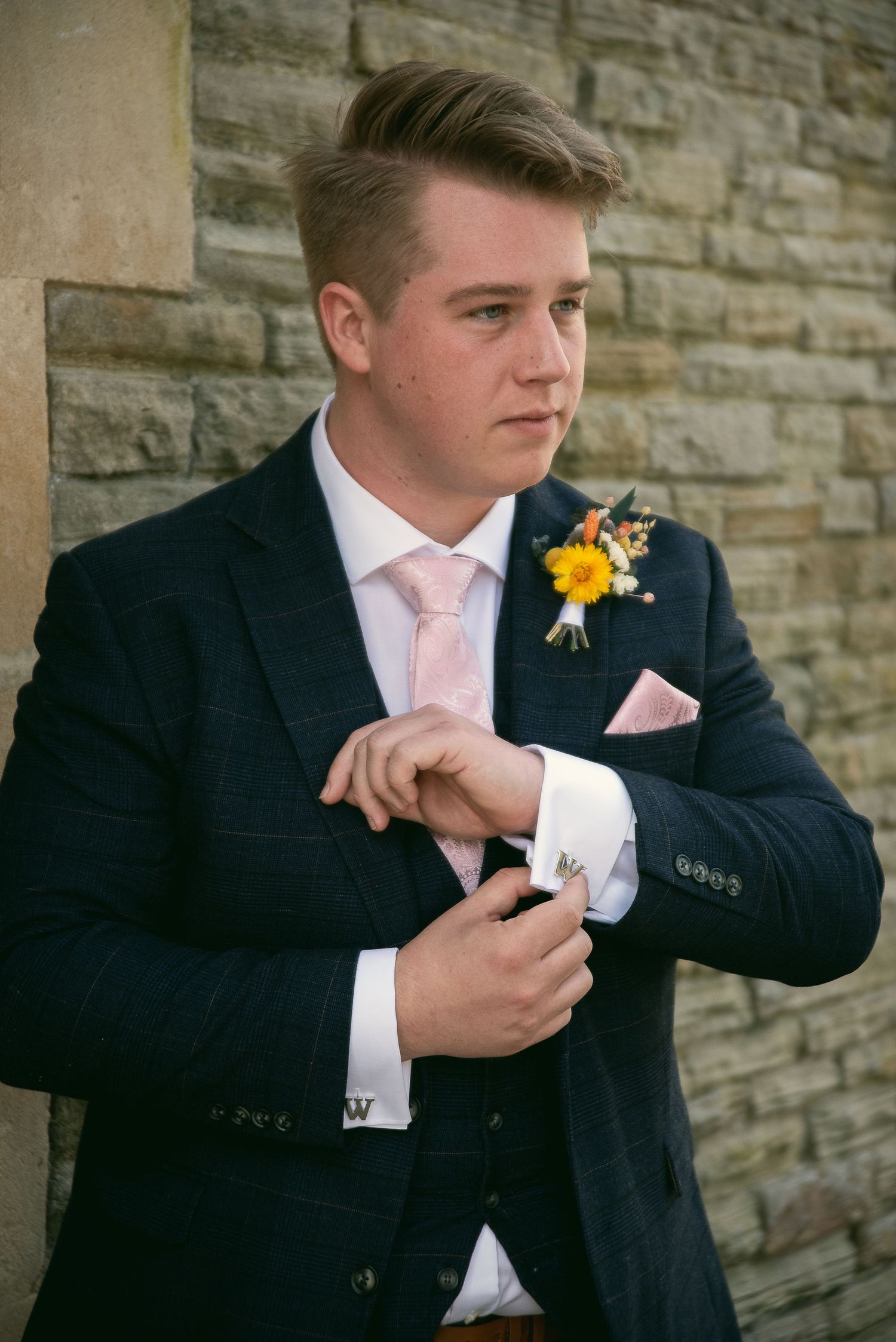 Sequence of a groomsman adjusting his cufflinks before the wedding ceremony.