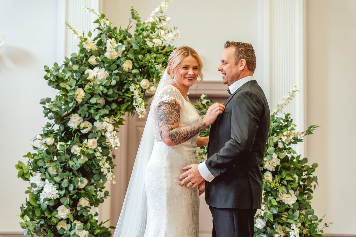 Candid shot of Bride and Groom laughing at the alter