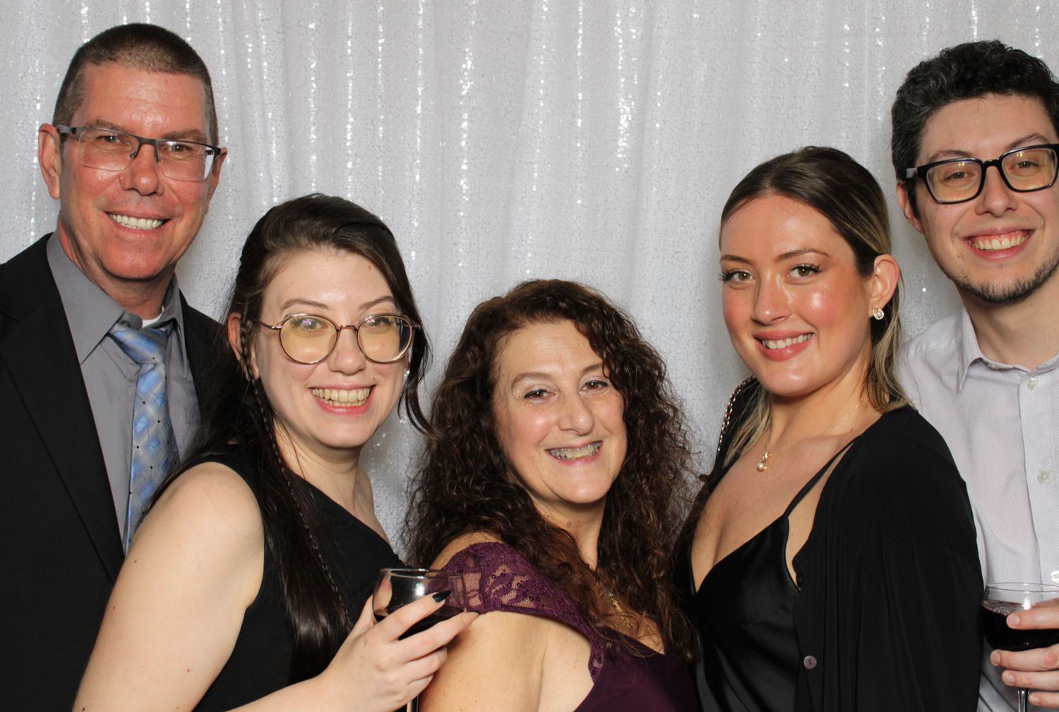 Photo booth collage of wedding guests posing and celebrating together.