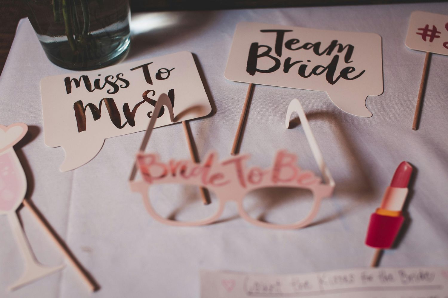 A collection of jigsaw puzzle pieces scattered across a white surface with handwritten text visible on them.