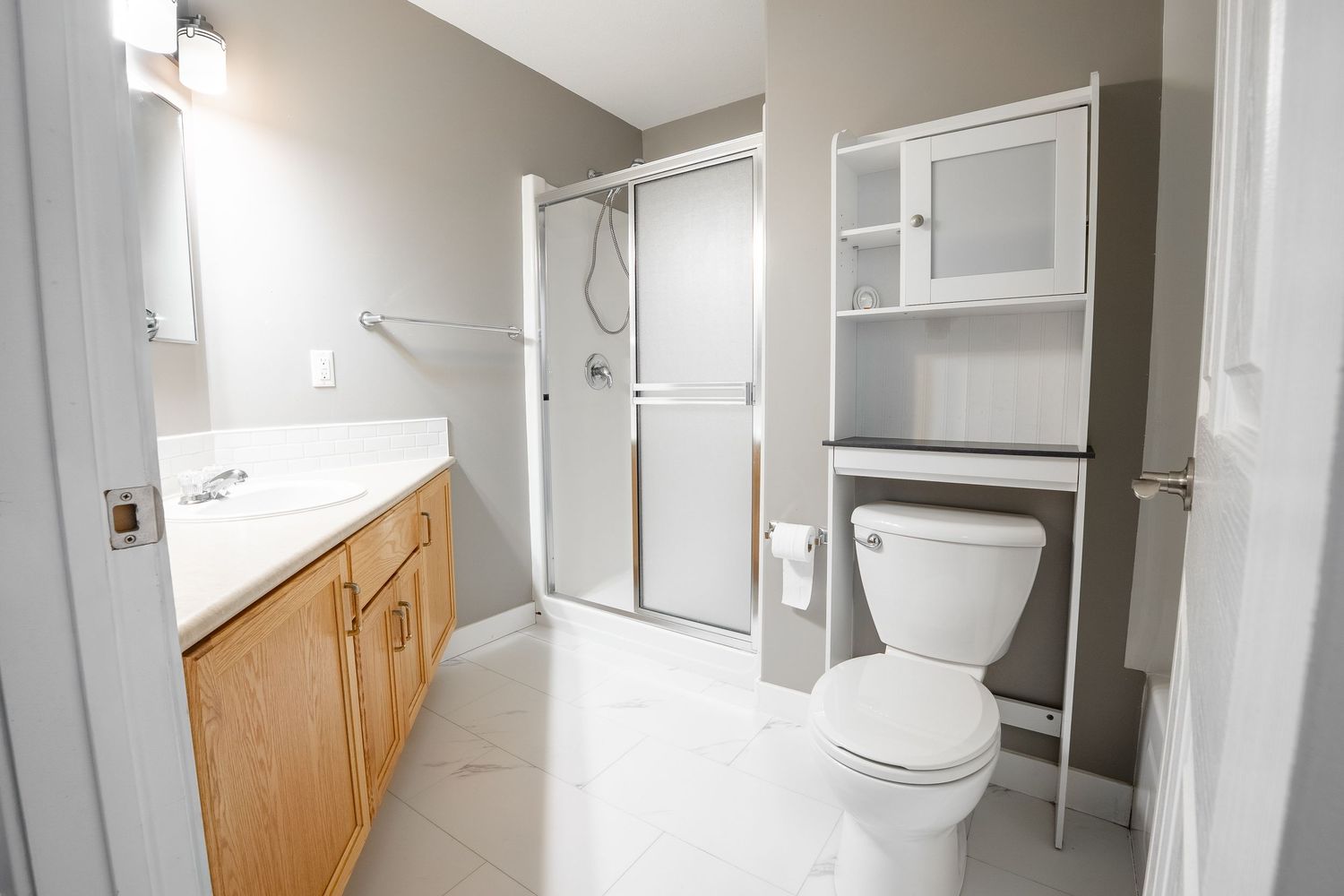 Bright white bathroom real estate photography in Saskatoon Saskatchewan highlighting clean design and fixtures.