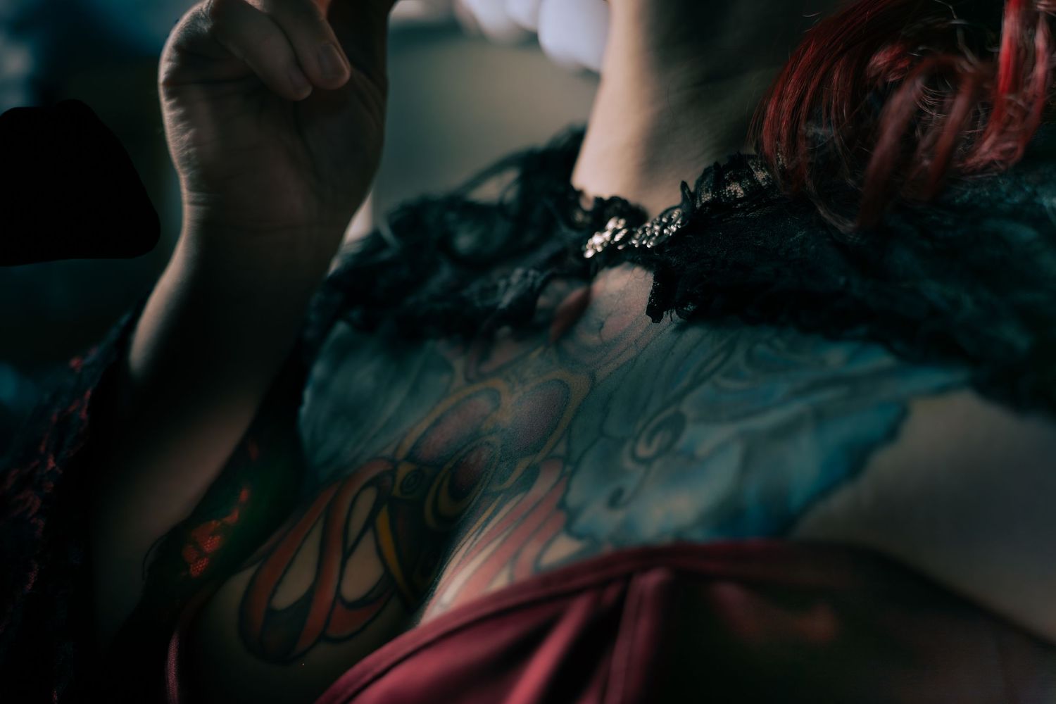Creative boudoir photography in Saskatoon Saskatchewan featuring confident pose and dark cinematic tones.