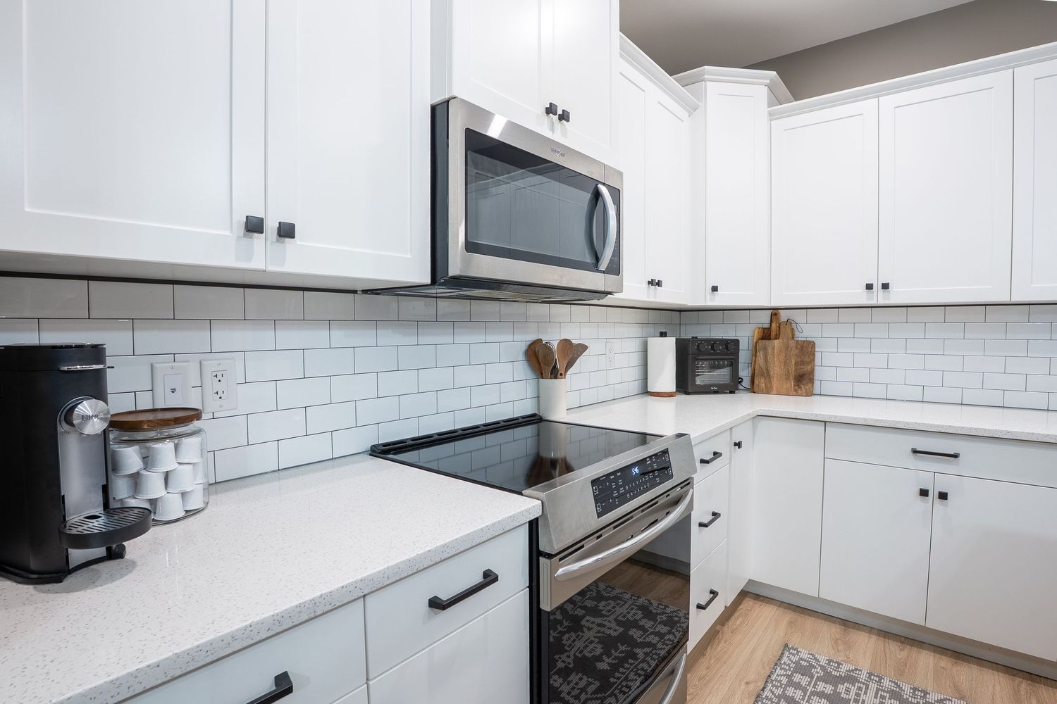 Modern kitchen real estate photography in Saskatoon Saskatchewan featuring white cabinets and open design.