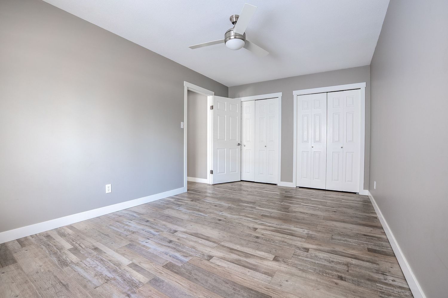 Empty bedroom interior real estate photography in Saskatoon Saskatchewan featuring bright walls and natural light.