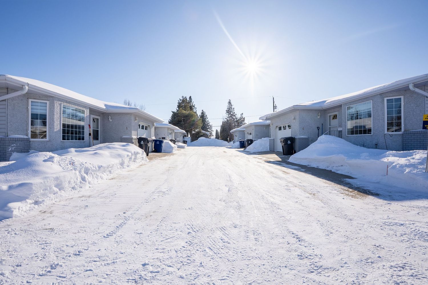 Snow covered home exterior real estate photography in Saskatoon Saskatchewan showcasing winter curb appeal.