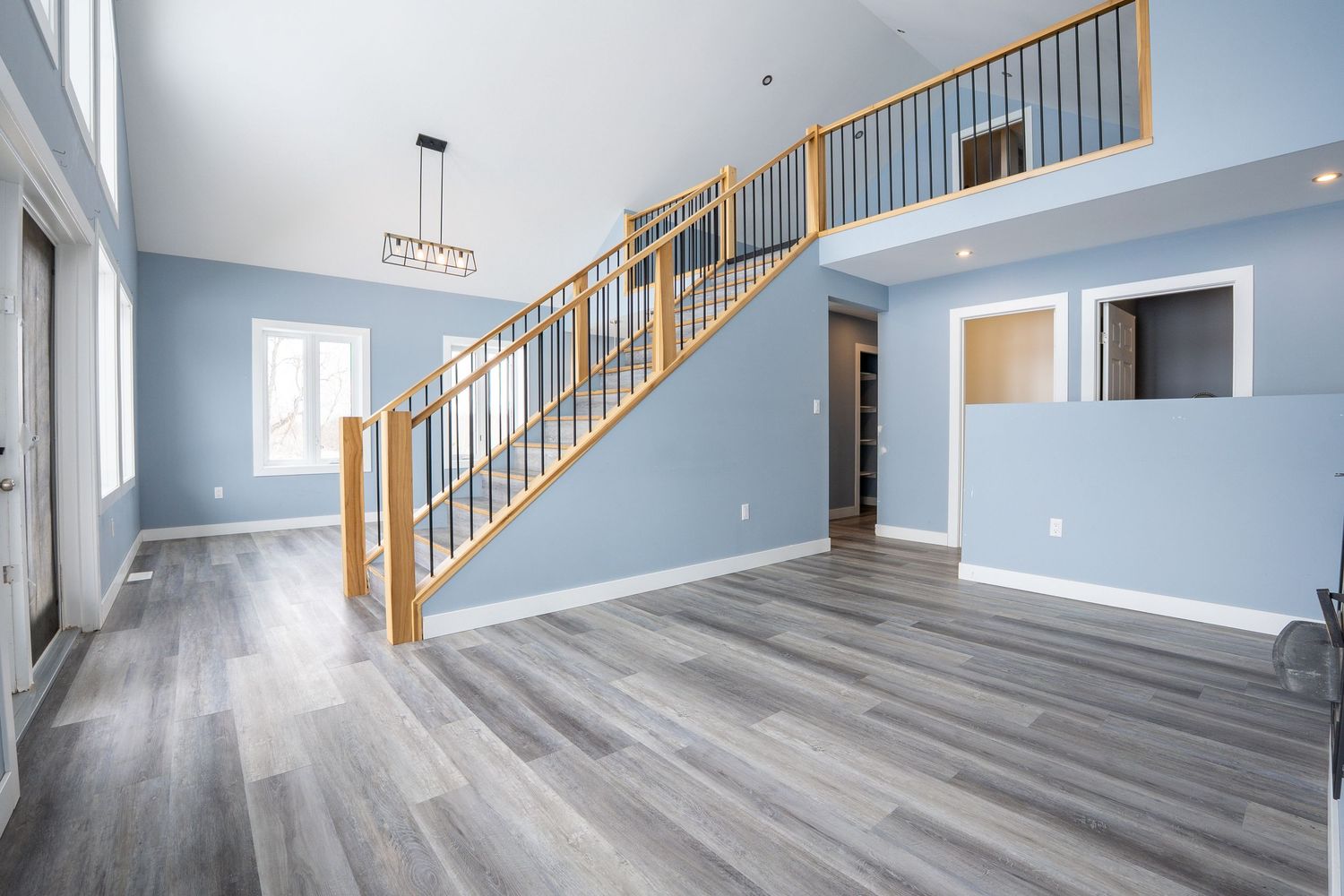 Spacious living room real estate photography in Saskatoon Saskatchewan with large open floor layout.
