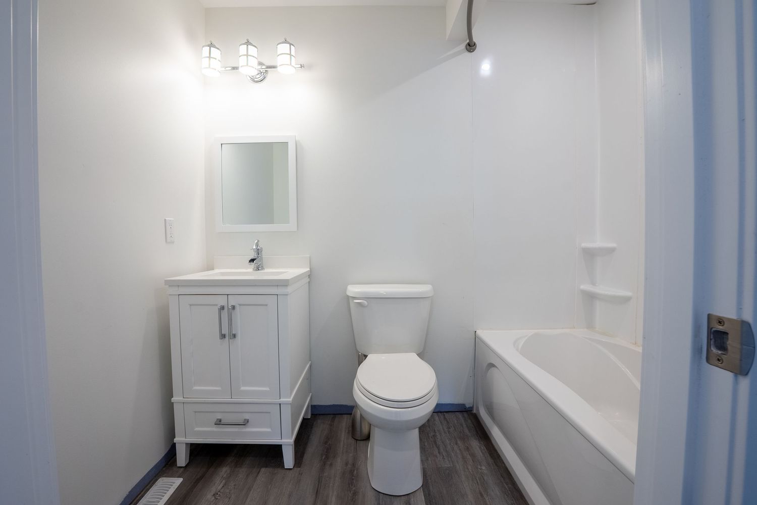 Bright white bathroom real estate photography in Saskatoon Saskatchewan highlighting clean design and fixtures.