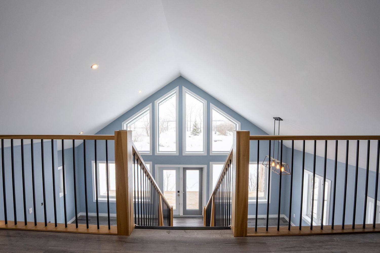 Living room with large windows real estate photography in Saskatoon Saskatchewan highlighting natural light.
