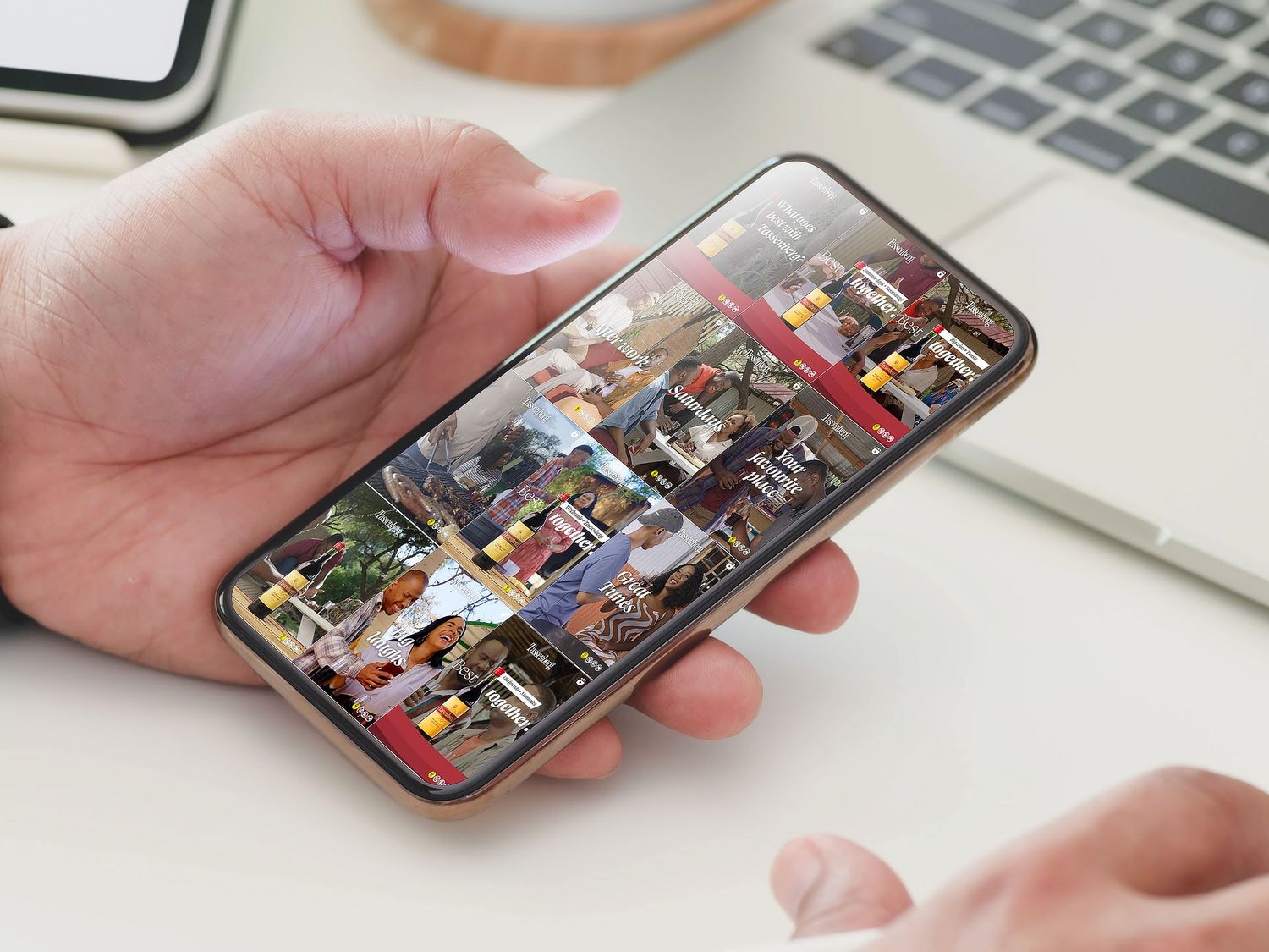 Hand holding a smartphone displaying a security camera surveillance grid with multiple live video feeds.