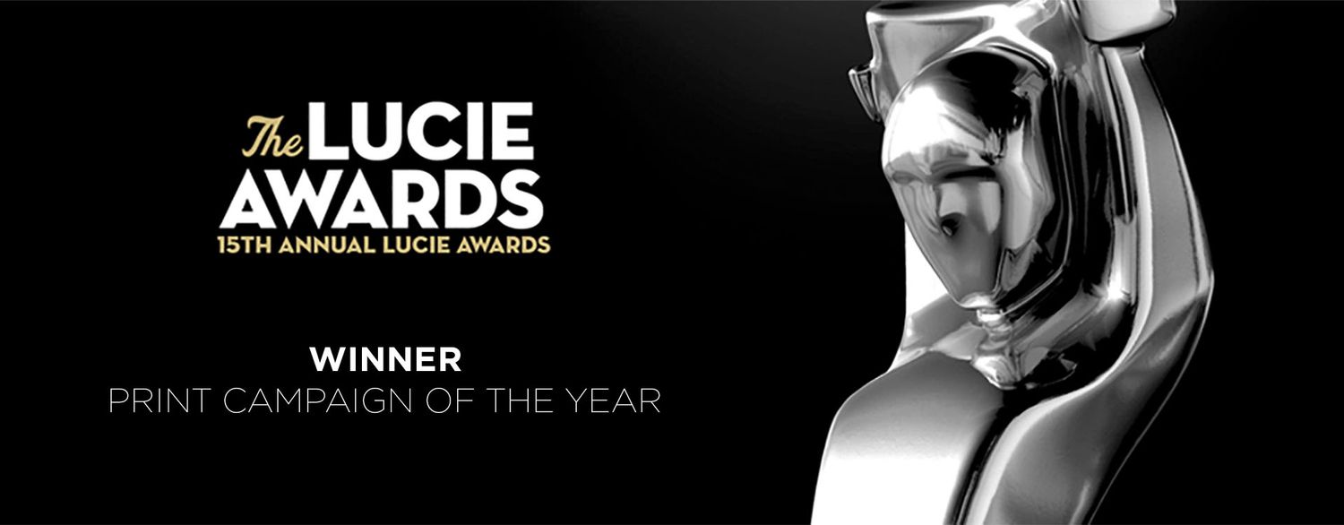 The Lucie Awards 15th Annual banner showcasing a Winner of Print Campaign of the Year trophy statue.