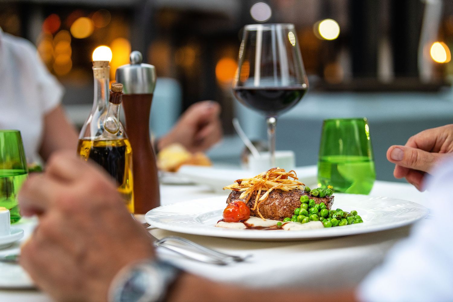 Gourmet steak dinner with red wine served at an upscale safari lodge restaurant.