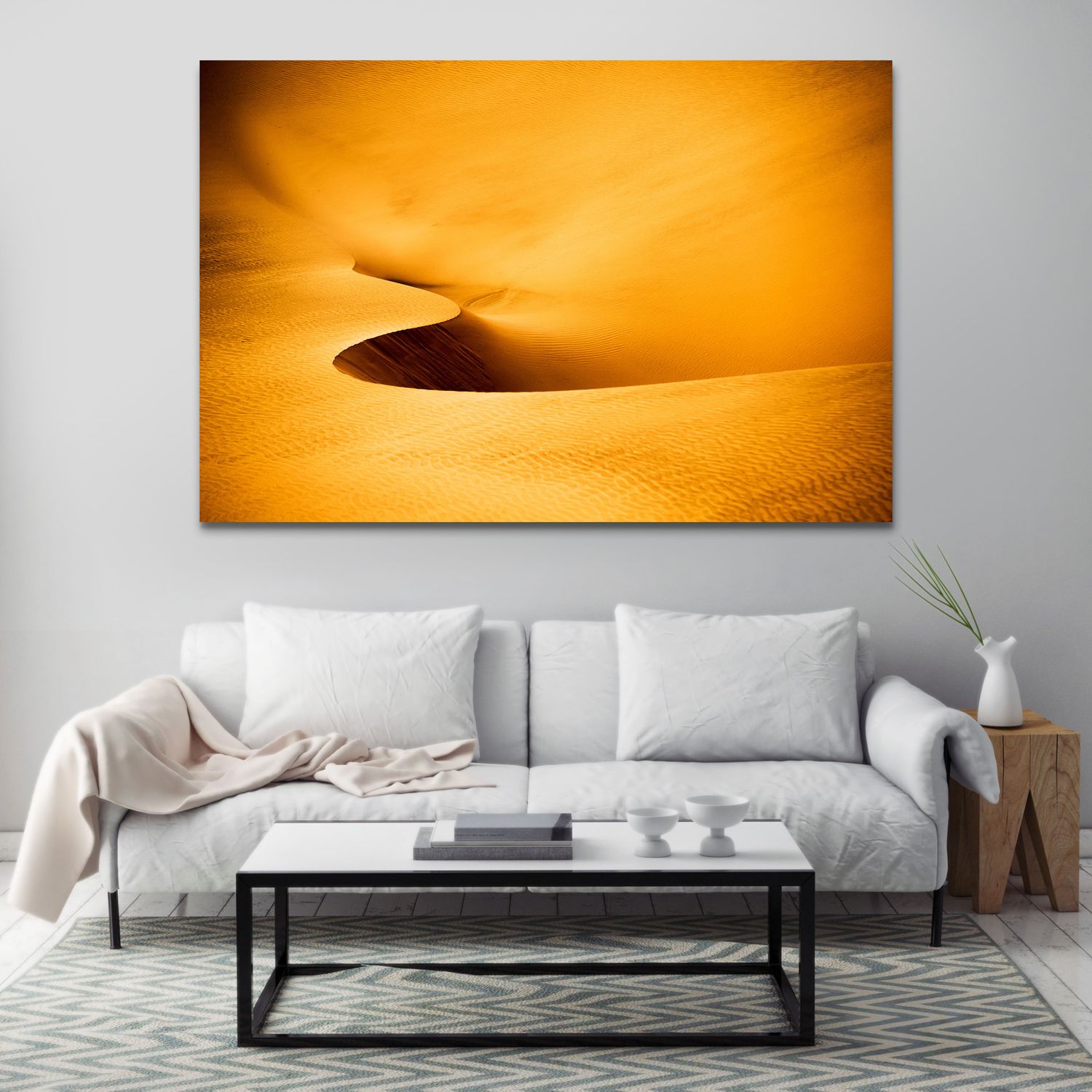 Canvas wall art of golden desert sand dunes displayed above a white sofa in a modern living room.
