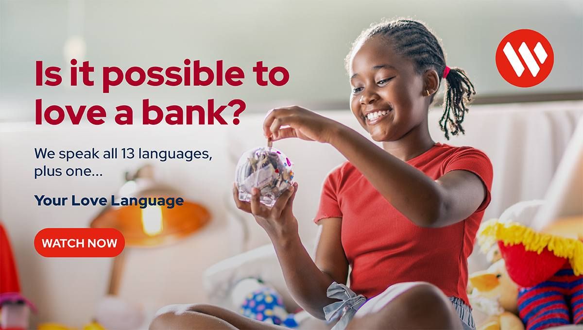 A young girl smiles while putting coins in a piggy bank, beside text asking if it is possible to love a bank.