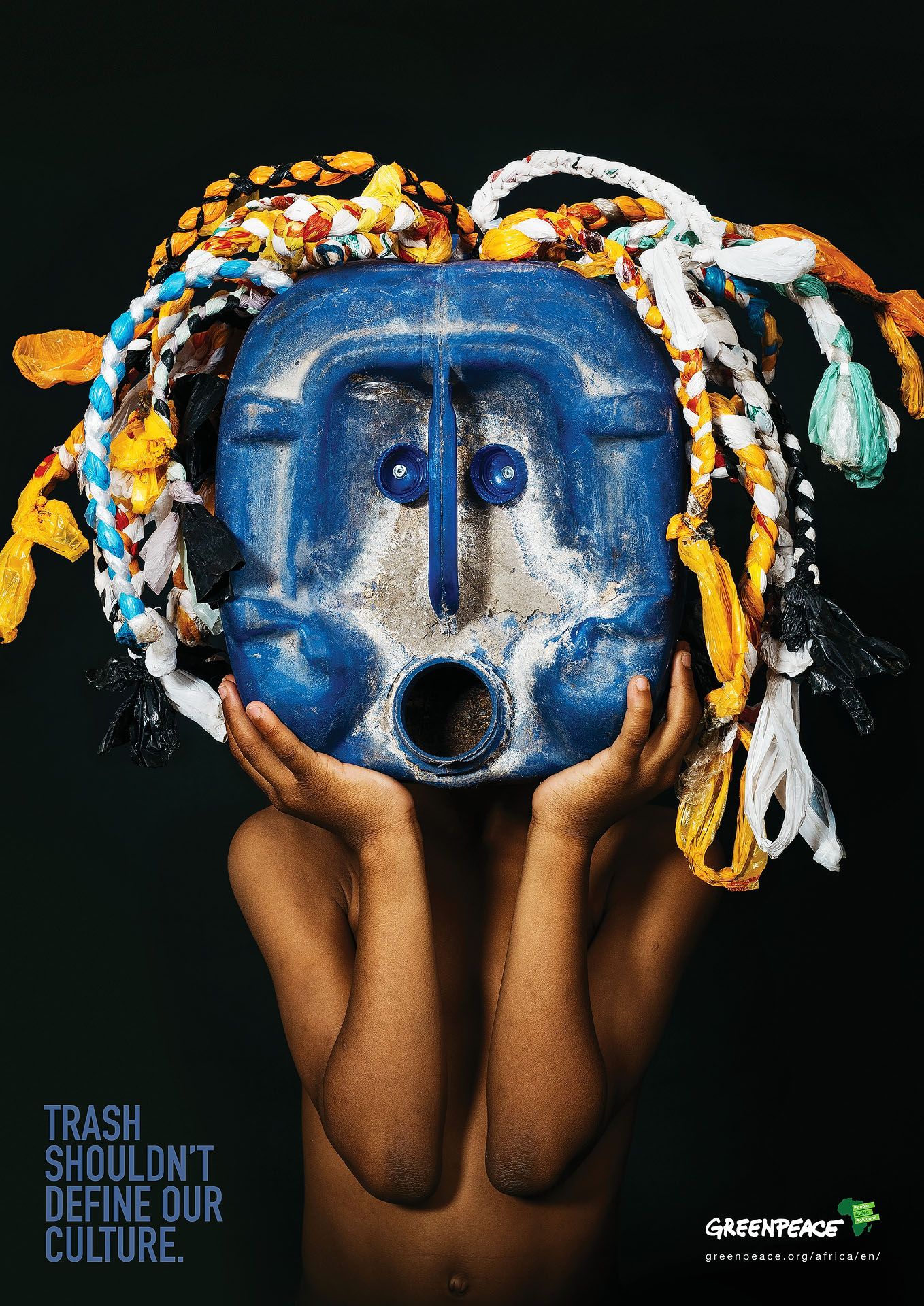 Greenpeace ad featuring a blue plastic jug mask with colorful plastic bag dreadlocks, captioned Trash Shouldn't Define Our Culture.