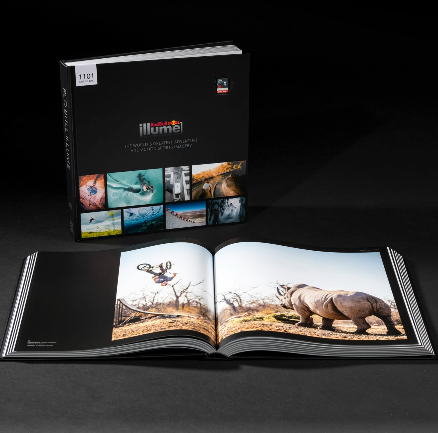 Illumi photography book displayed open to a rhino page, with box set featuring wildlife and action images on dark background.
