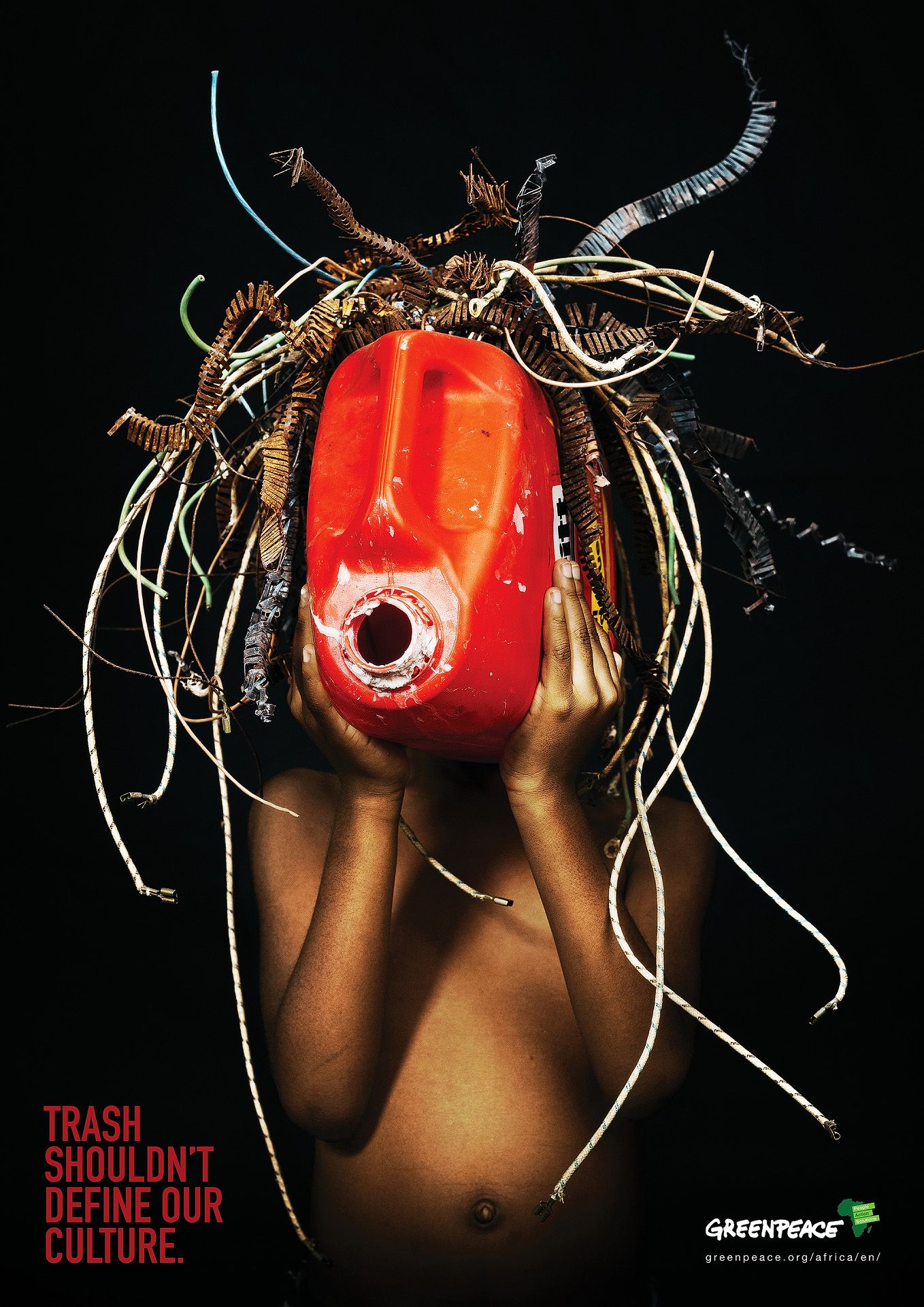 Greenpeace ad showing person holding red gas can with wires as hair, text reads Trash Shouldn't Define Our Culture.