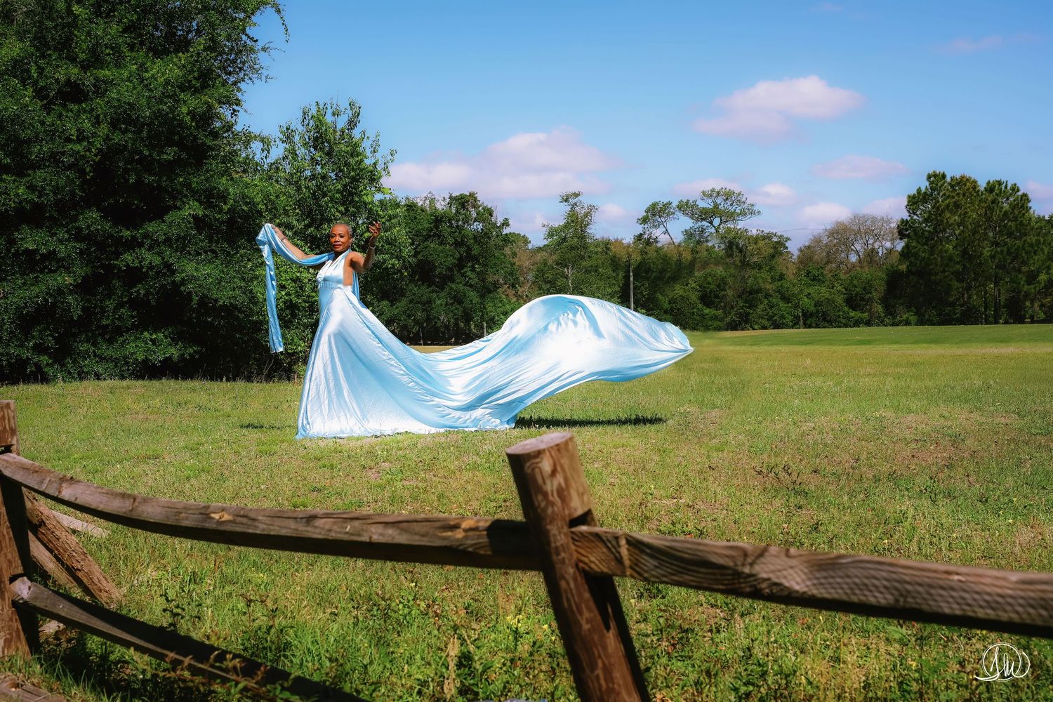 Flying dress photographer Jacksonville - outdoor portrait by fence line Blue Cypress Park