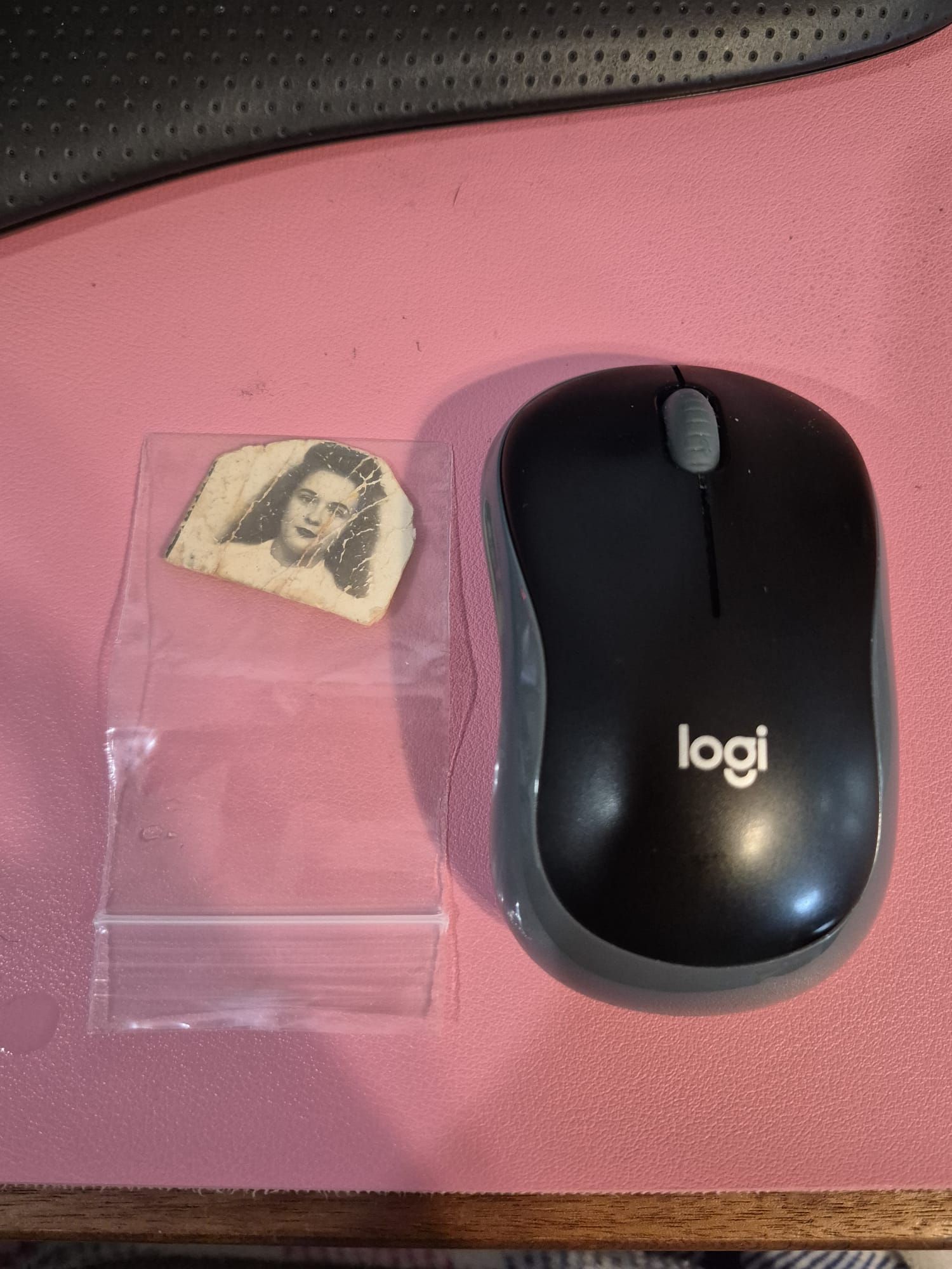 Shattered vintage photograph next to a computer mouse showing how small the original damaged photo was