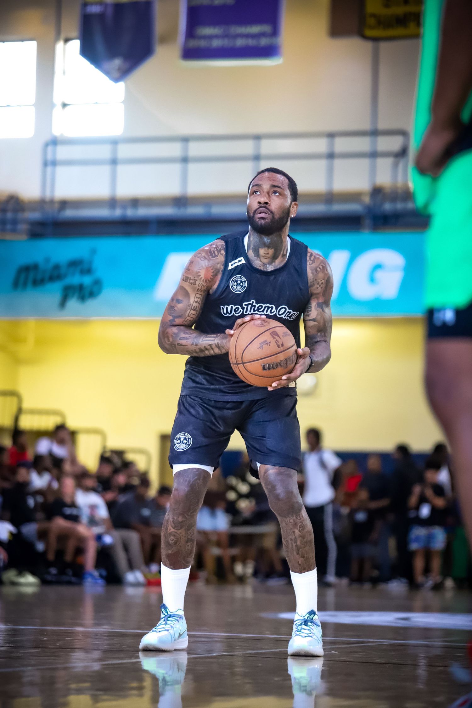 John Wall professional baseball player wearing a black uniform taking a free throw shot.
