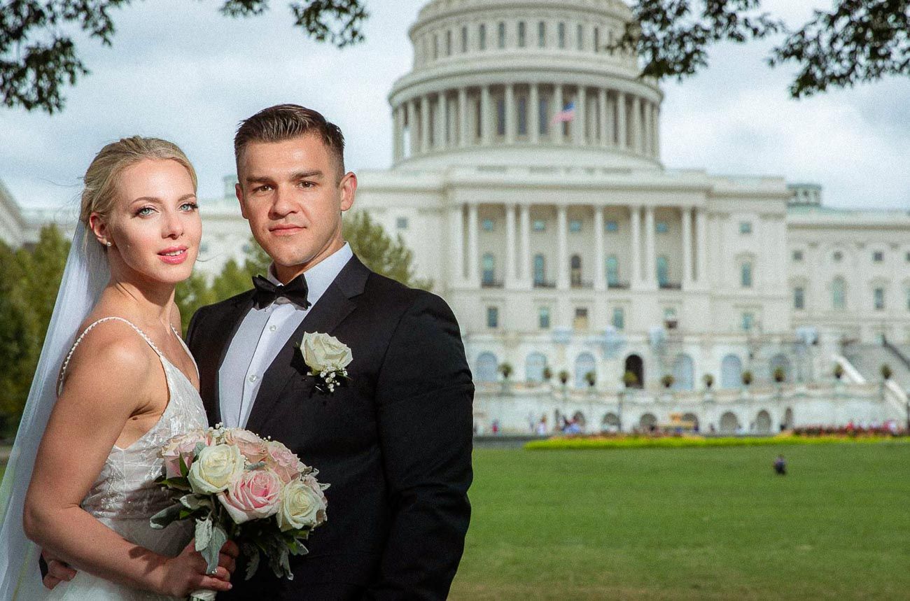 Wedding couple posing closely together with the iconic US Capitol dome prominently featured in the background.