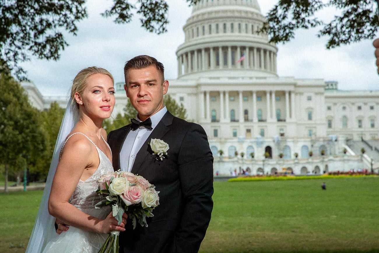 Elegant bride and groom share a romantic wedding portrait in front of the US Capitol.