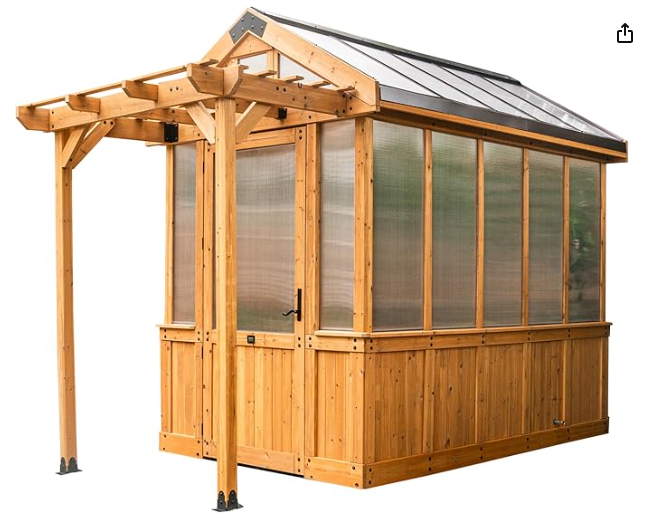 A wooden outdoor greenhouse or sunroom with cedar framing, clear panels, and an attached pergola-style overhang on one side.
